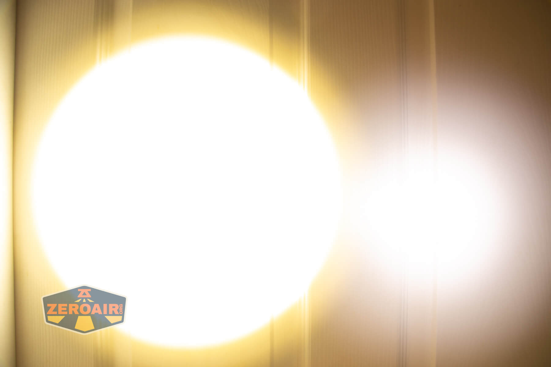 Armytek Viking Pro Magnet USB tactical flashlight beamshots on door (at 1') compared to nichia 219b 4500K