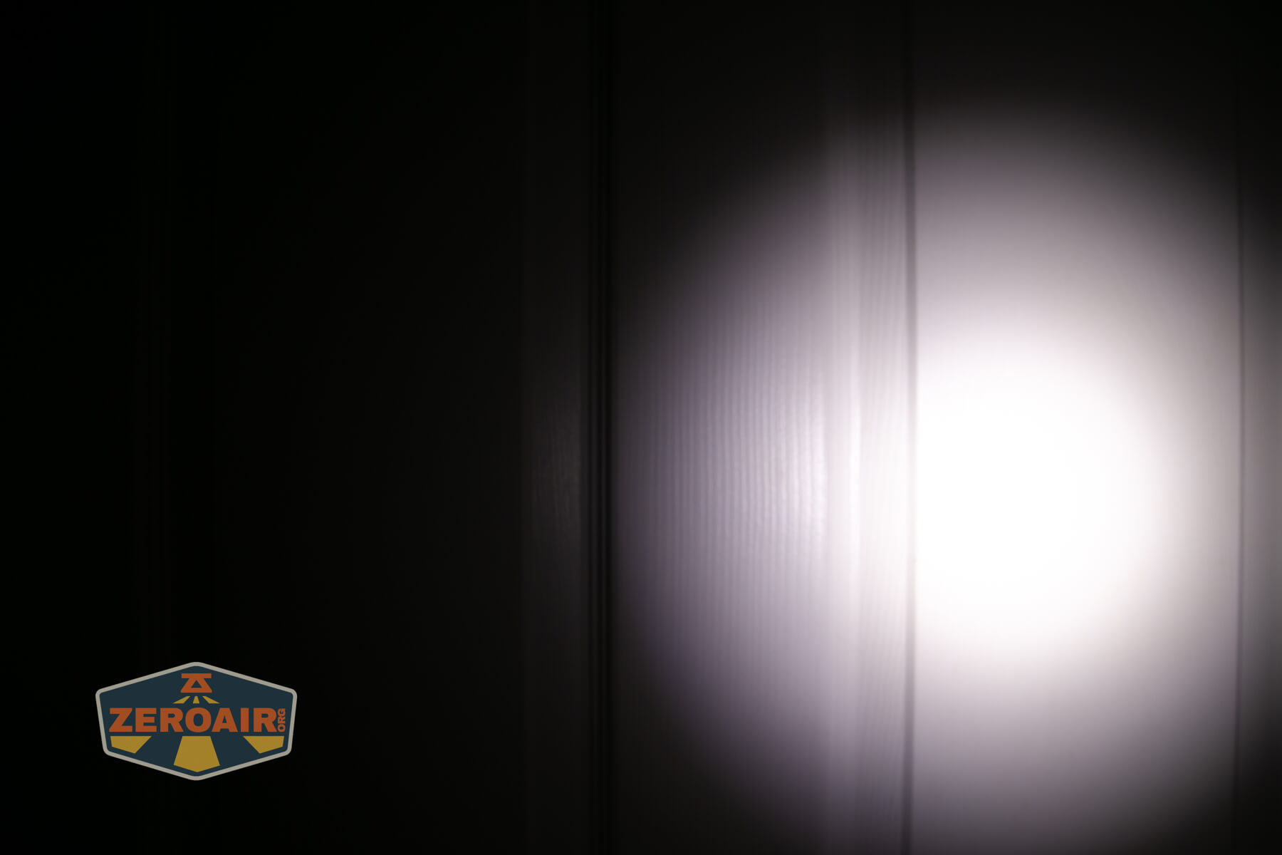 LoopGear LoopDot Pixel Display EDC flashlight beamshots on door (at 1') compared to nichia 219b 4500K