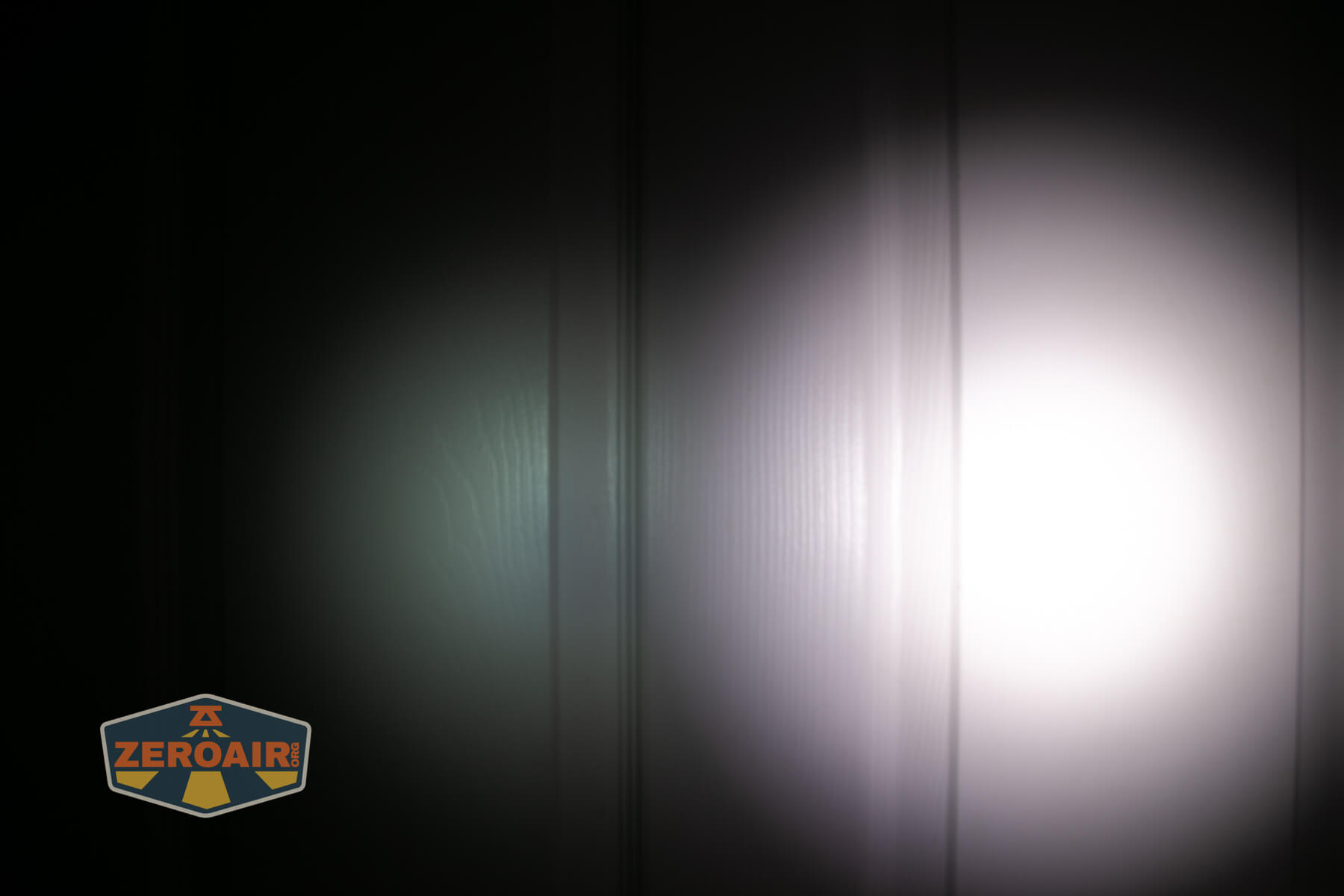 LoopGear LoopDot Pixel Display EDC flashlight beamshots on door (at 1') compared to nichia 219b 4500K