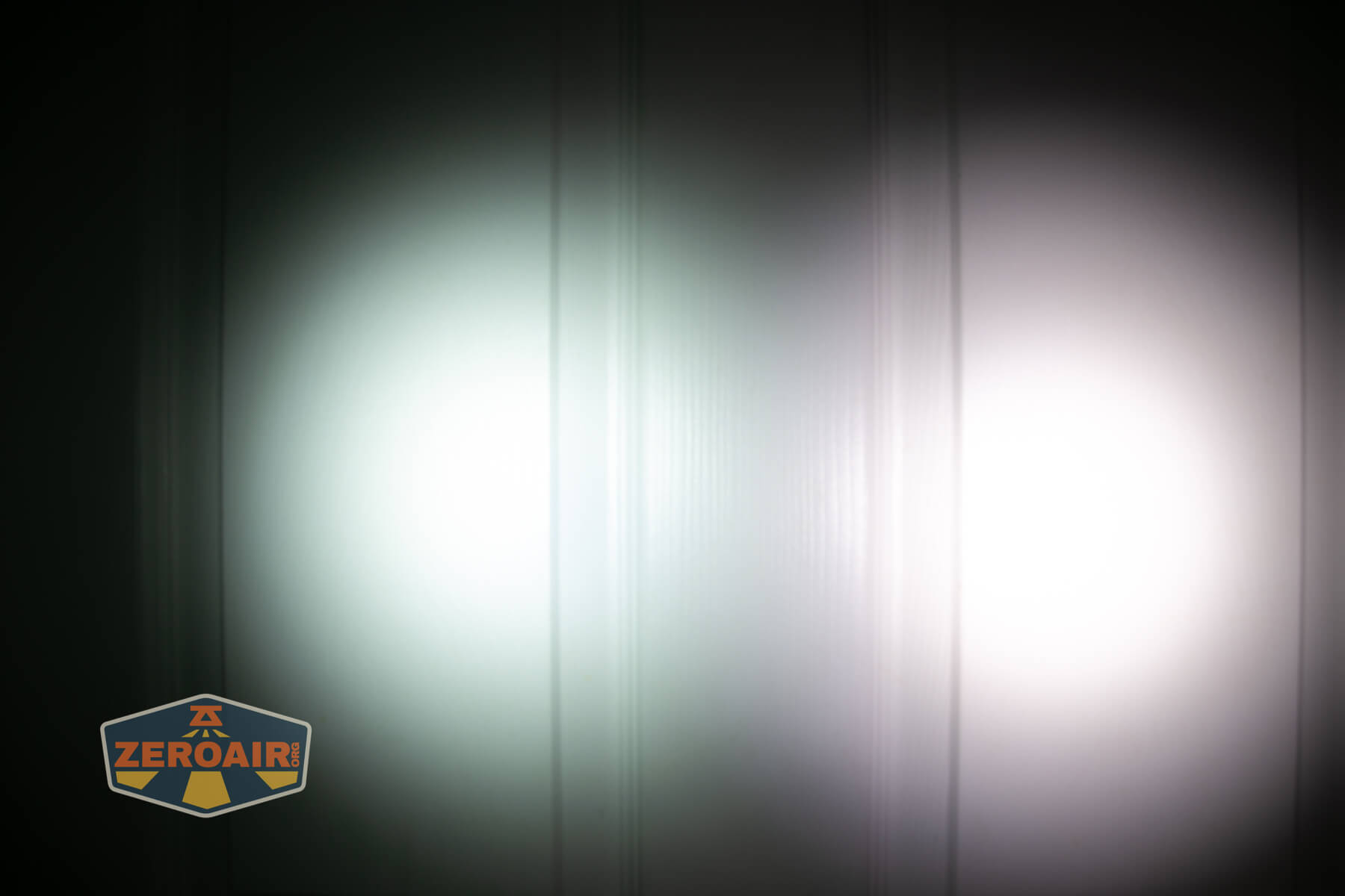 LoopGear LoopDot Pixel Display EDC flashlight beamshots on door (at 1') compared to nichia 219b 4500K