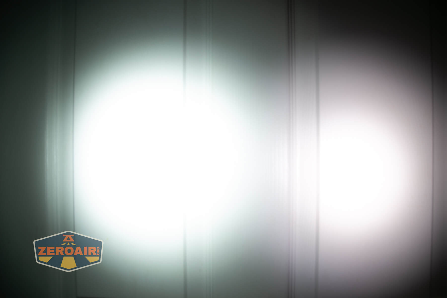 LoopGear LoopDot Pixel Display EDC flashlight beamshots on door (at 1') compared to nichia 219b 4500K