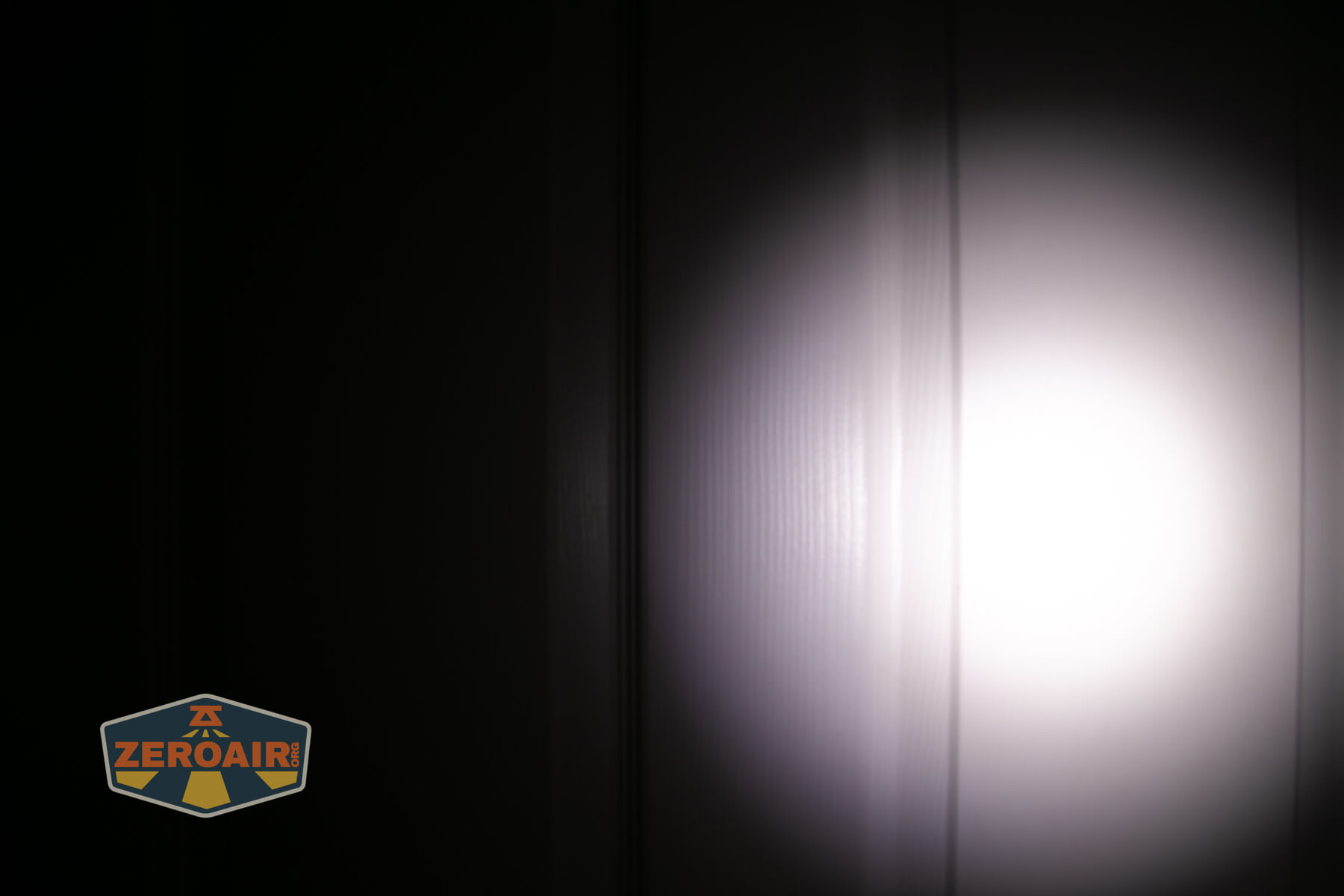 LoopGear LoopDot Pixel Display EDC flashlight beamshots on door (at 1') compared to nichia 219b 4500K