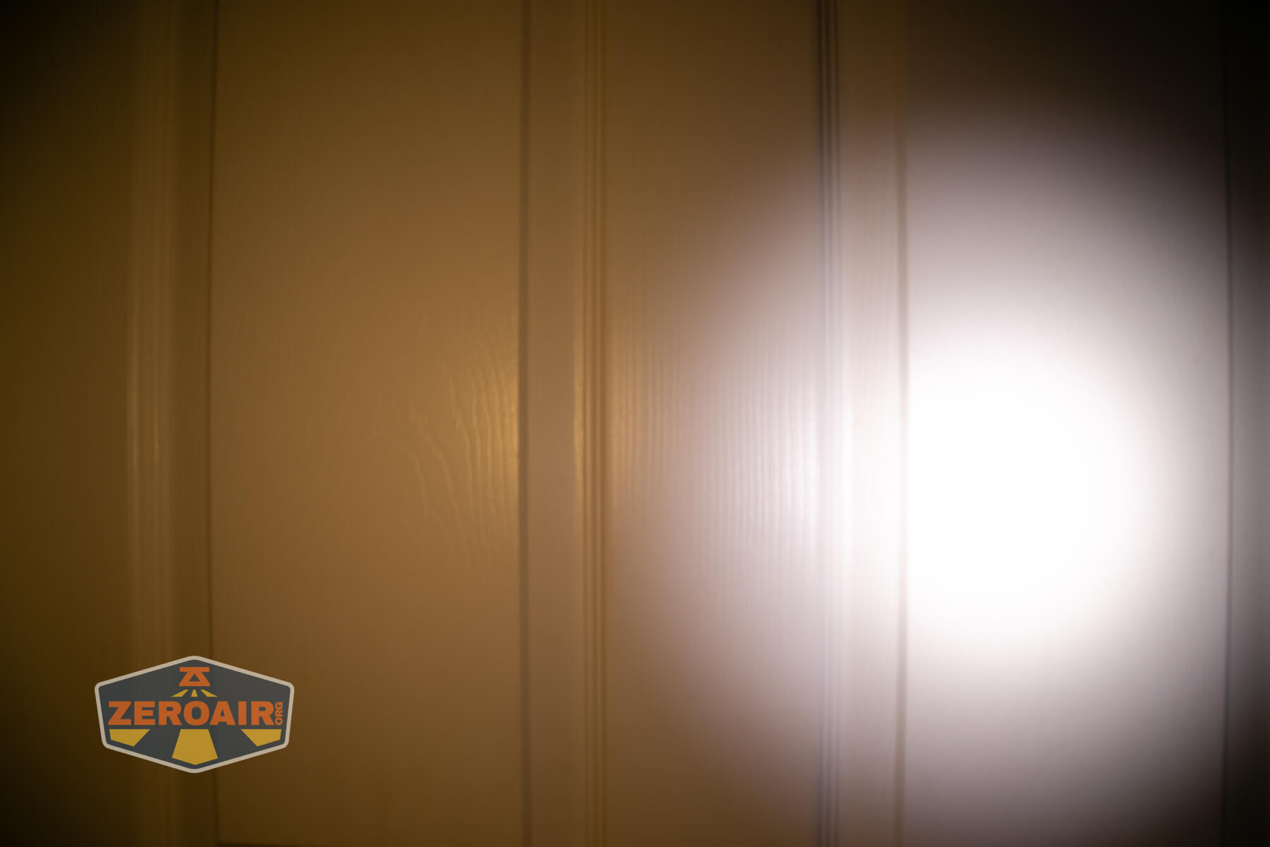 LoopGear LoopDot Pixel Display EDC flashlight beamshots on door (at 1') compared to nichia 219b 4500K