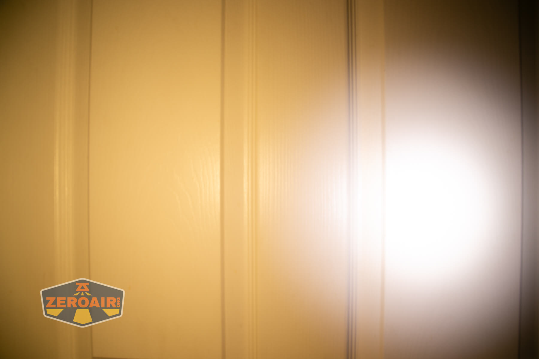 LoopGear LoopDot Pixel Display EDC flashlight beamshots on door (at 1') compared to nichia 219b 4500K