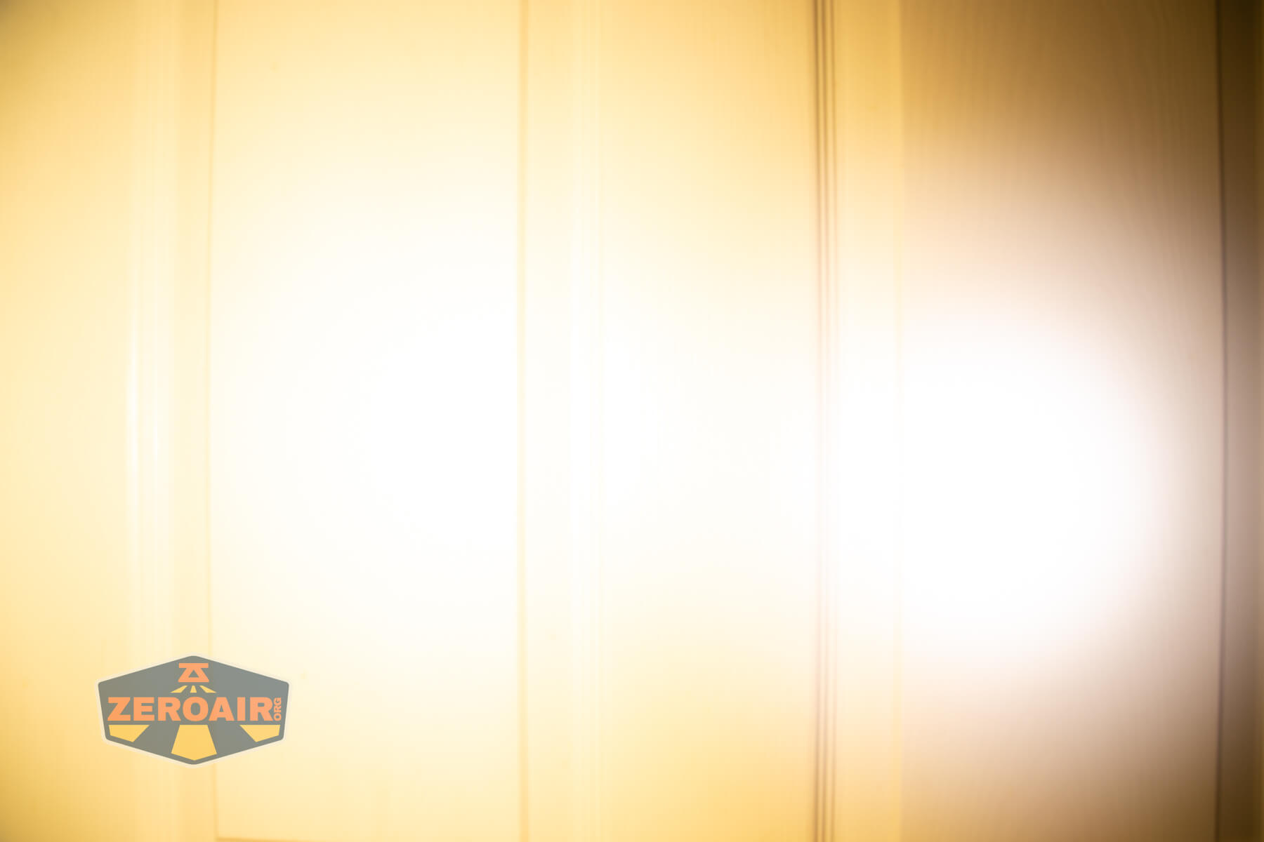 LoopGear LoopDot Pixel Display EDC flashlight beamshots on door (at 1') compared to nichia 219b 4500K