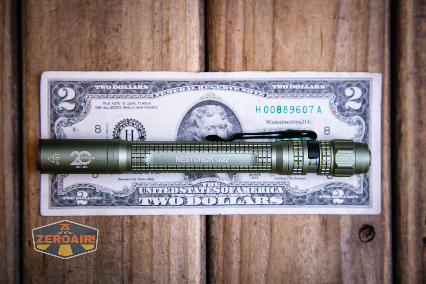 Nextorch TA22 20th anniversary penlight on a two dollar bill
