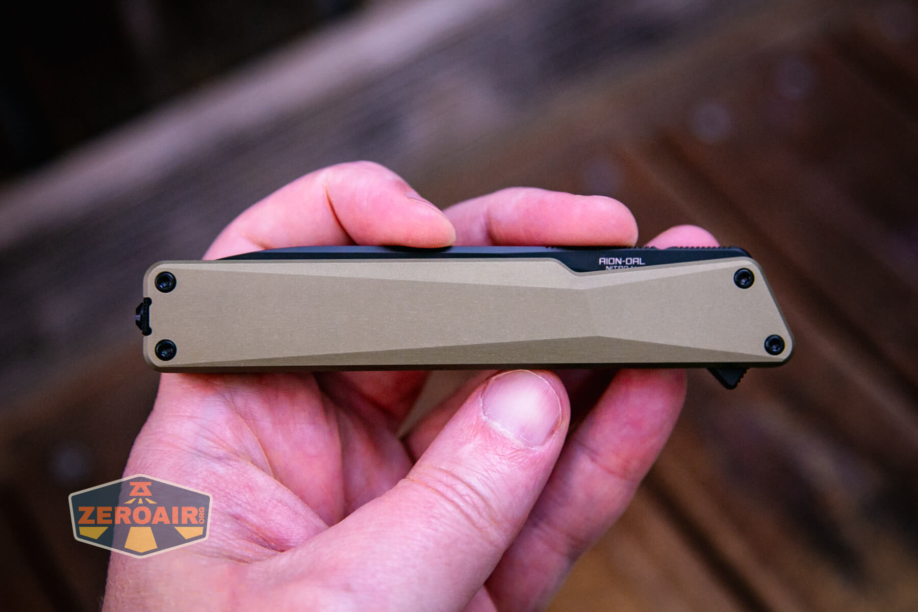 Olight Aion Gentleman's folding knife in hand