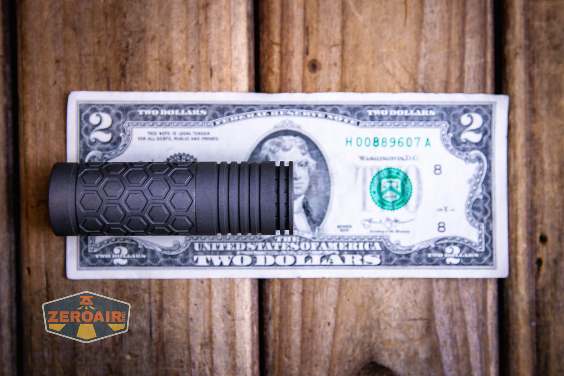 Reylight Dawn Hex-Ti 18350 flashlight on a two dollar bill