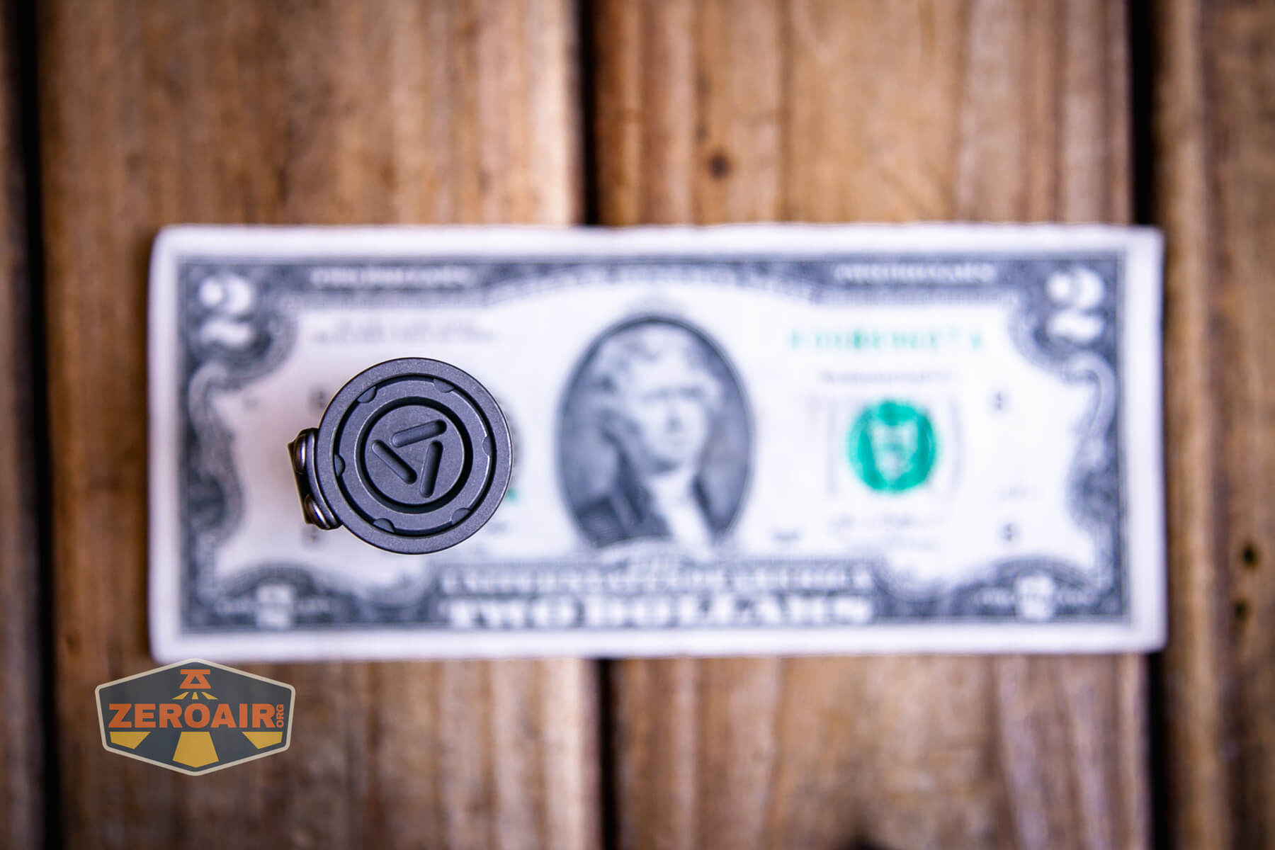 Reylight Dawn Hex-Ti 18350 flashlight on a two dollar bill