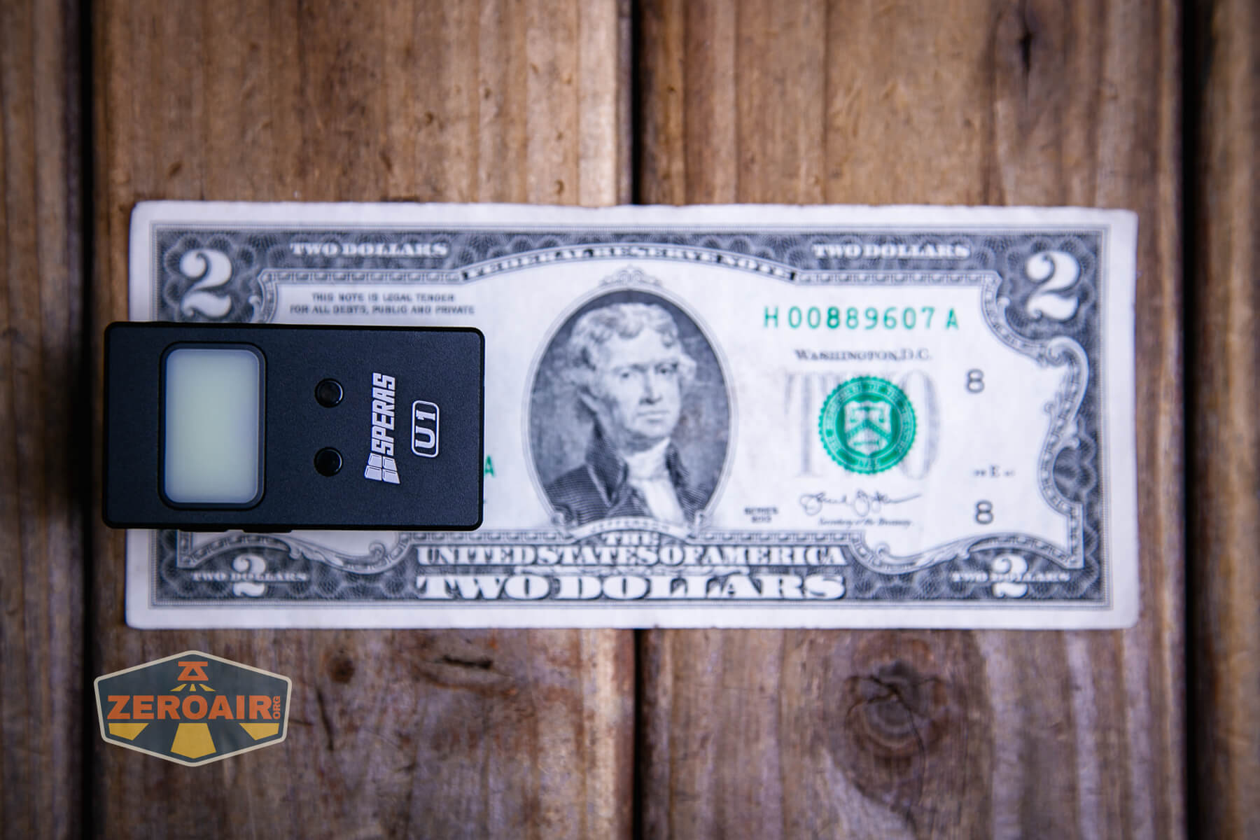 Speras U1 multi-function clip light on a two dollar bill