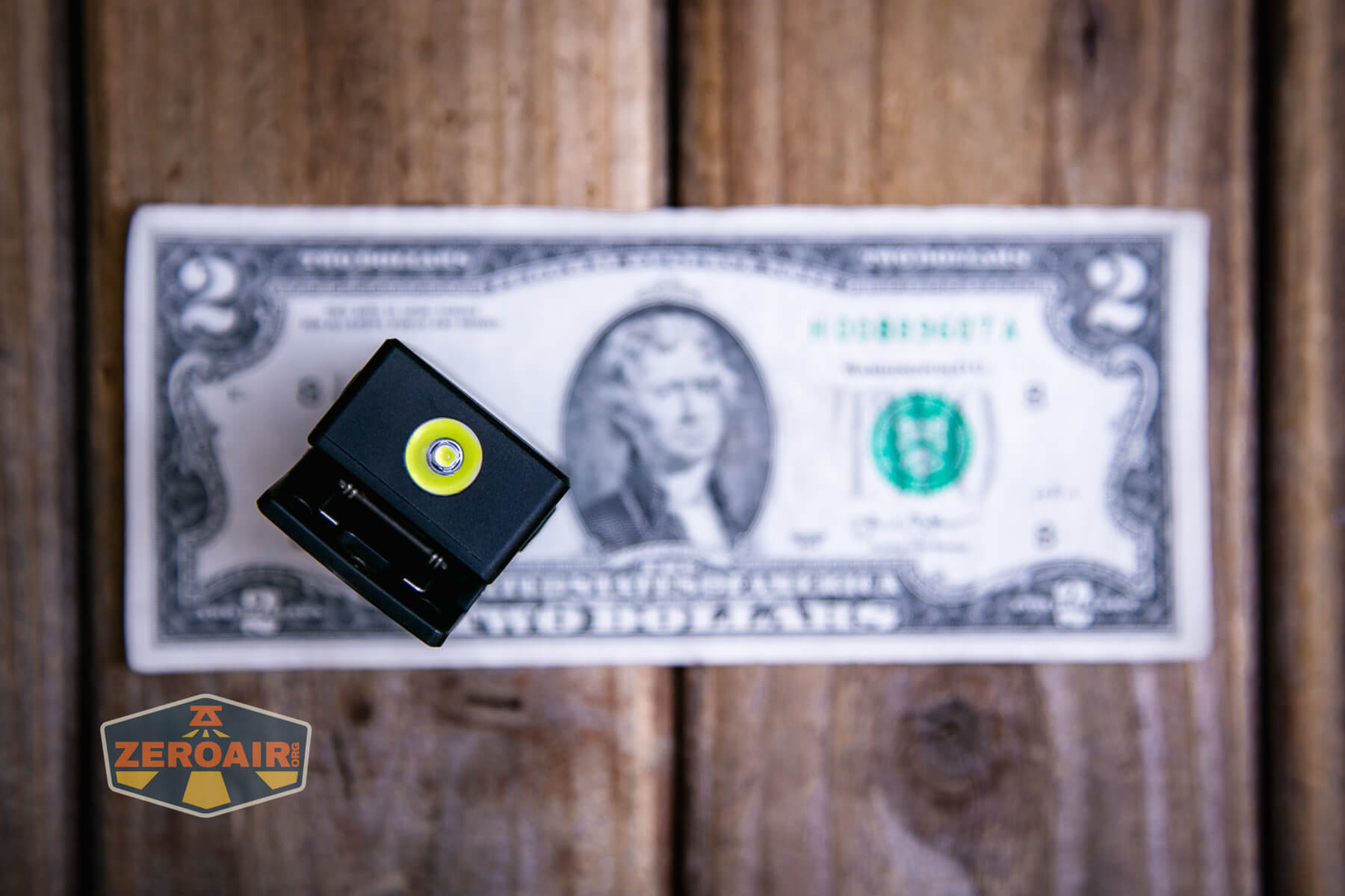 Speras U1 multi-function clip light on a two dollar bill