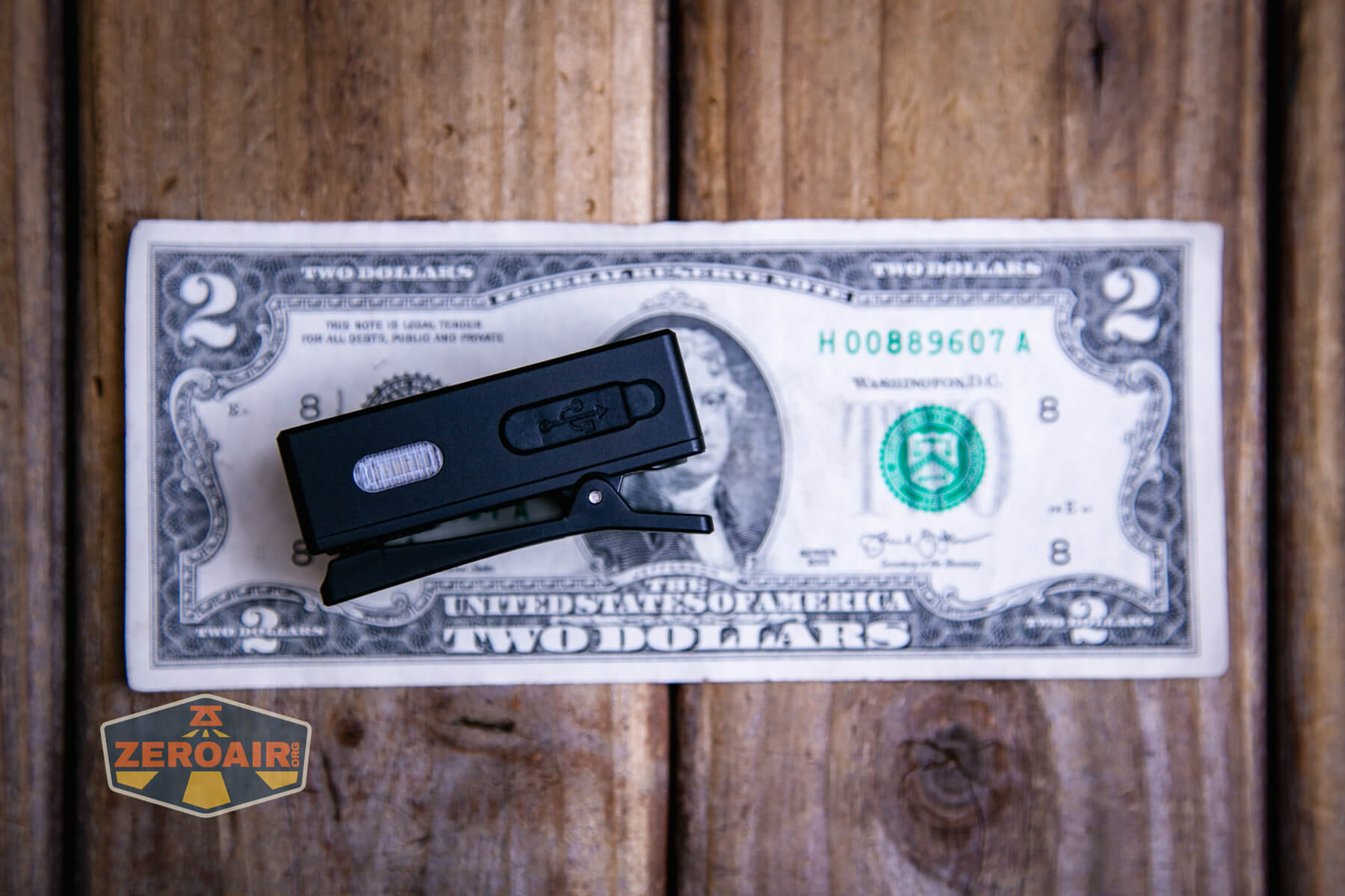 Speras U1 multi-function clip light on a two dollar bill