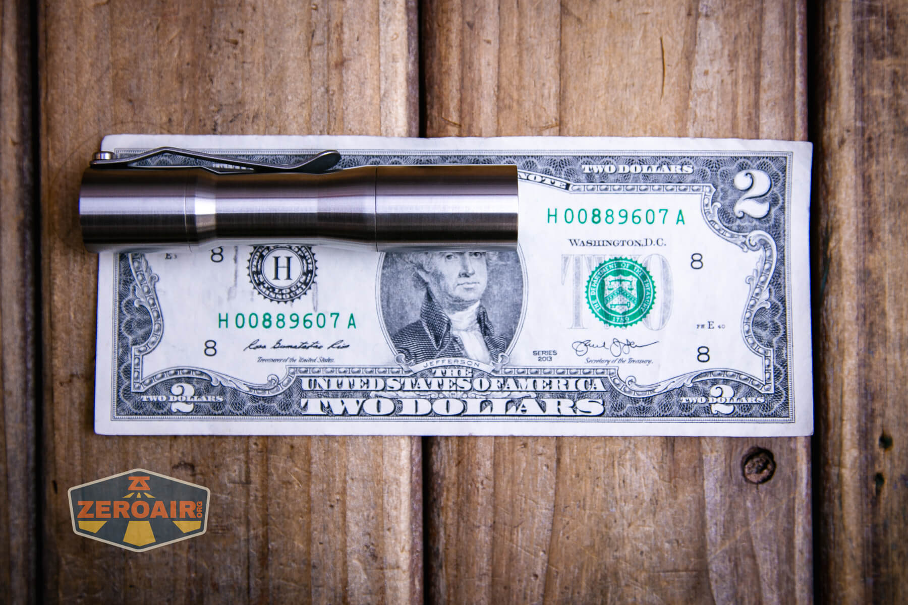 CWF Mini Arc flashlight on a two dollar bill
