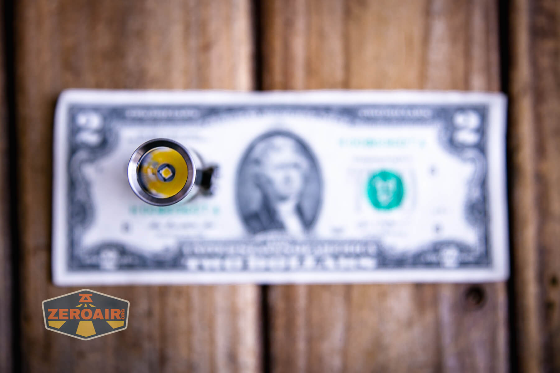 CWF Mini Arc flashlight on a two dollar bill