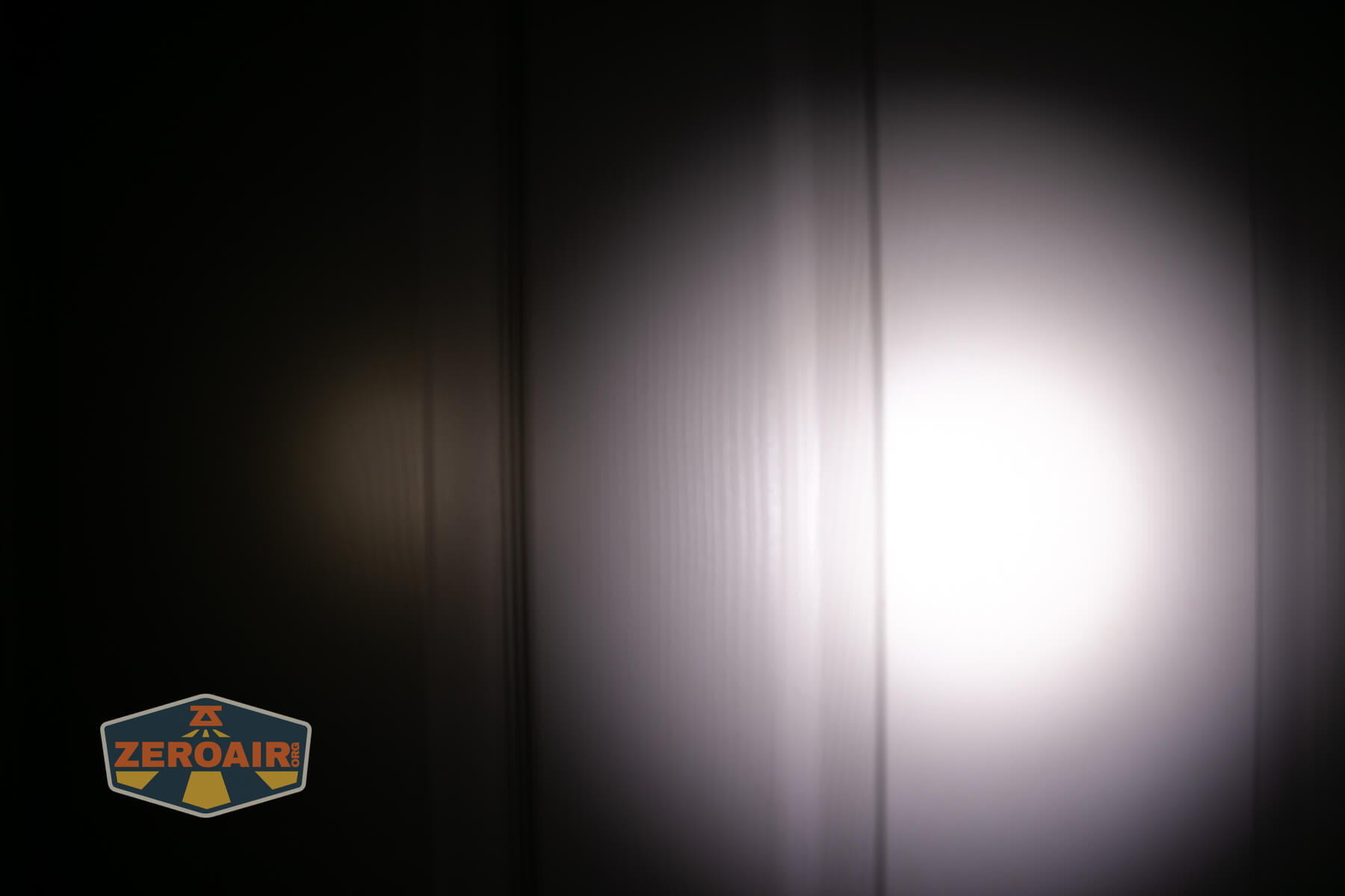 CWF Mini Arc flashlight beamshots on door (at 1') compared to nichia 219b 4500K