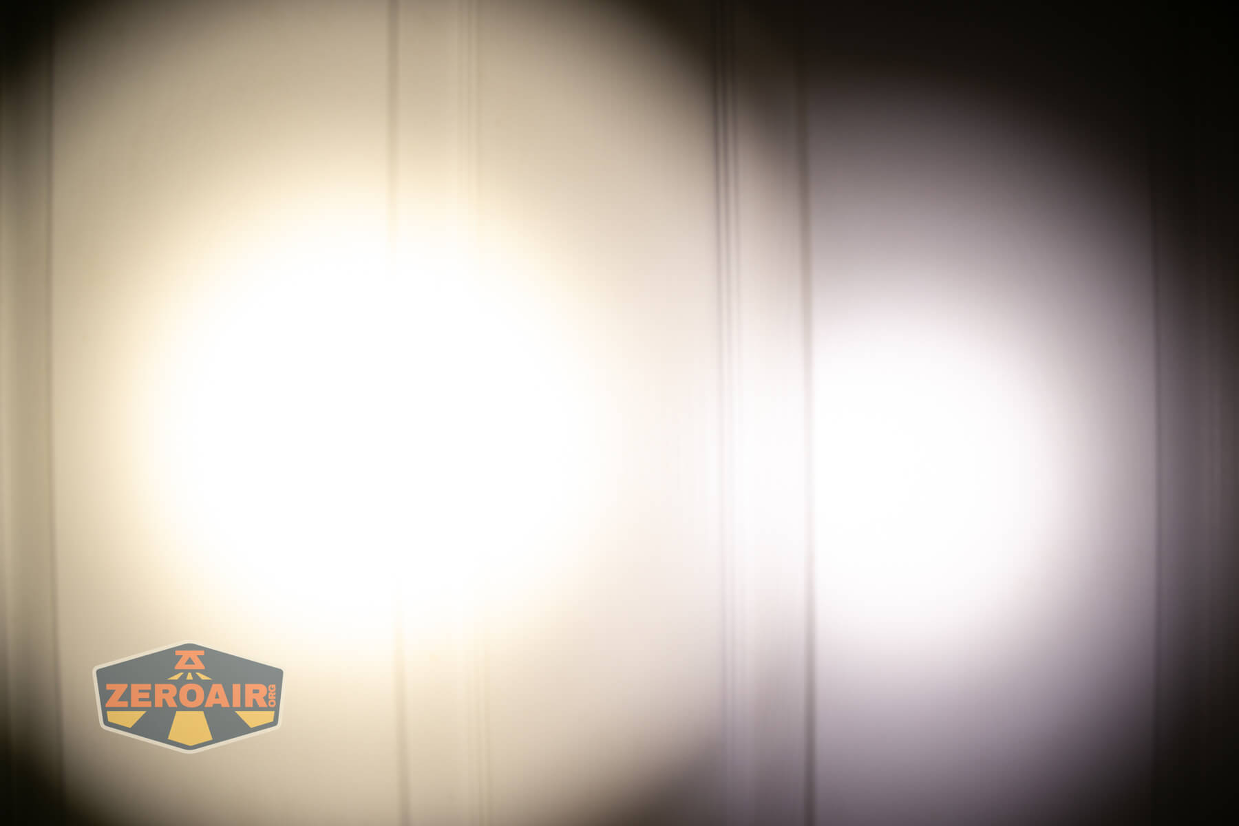 CWF Mini Arc flashlight beamshots on door (at 1') compared to nichia 219b 4500K