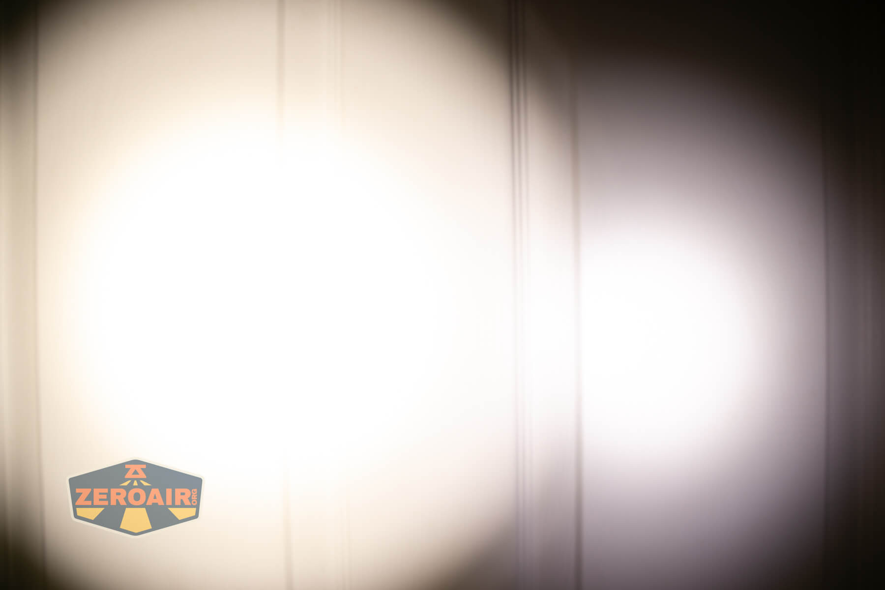 CWF Mini Arc flashlight beamshots on door (at 1') compared to nichia 219b 4500K