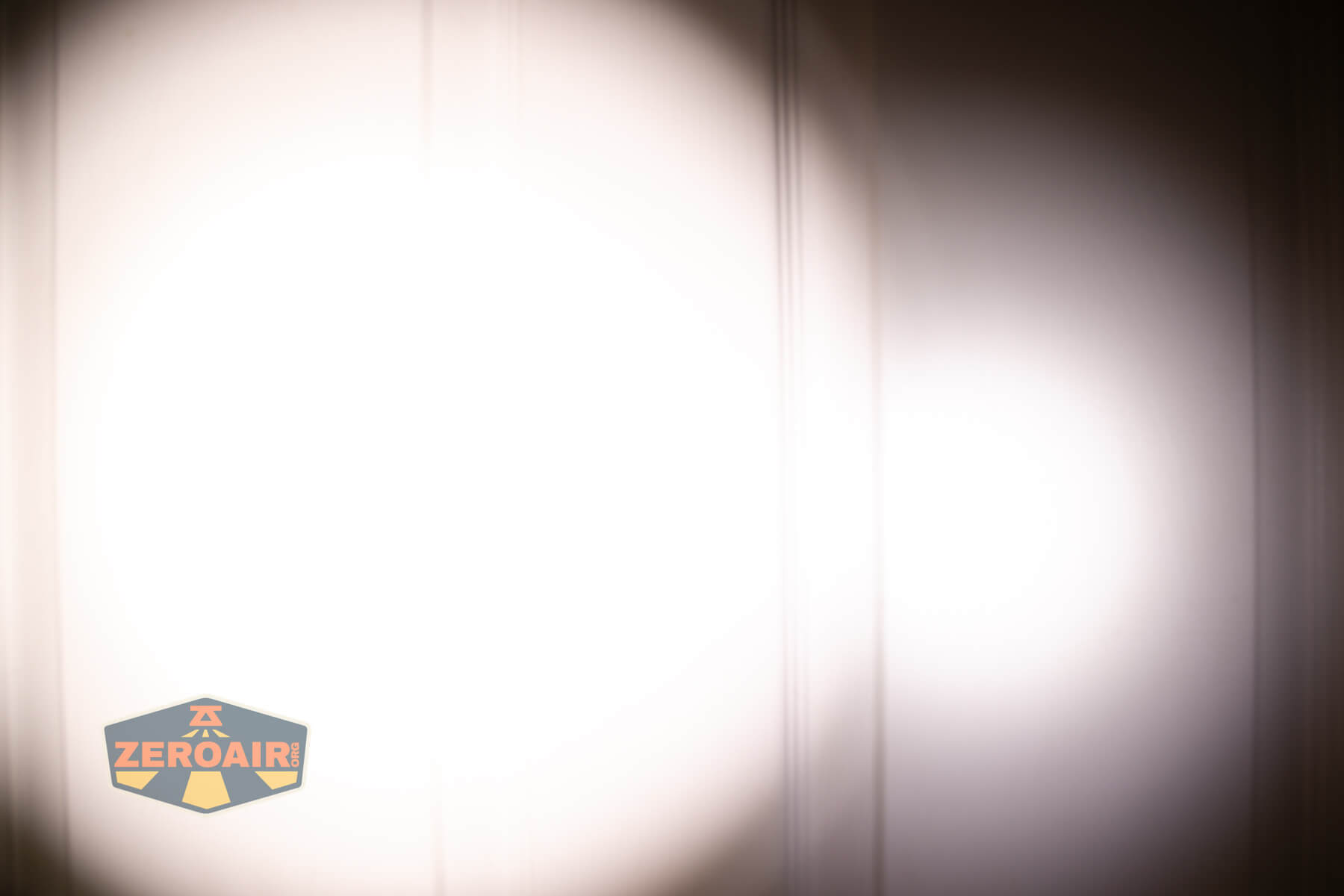 CWF Mini Arc flashlight beamshots on door (at 1') compared to nichia 219b 4500K