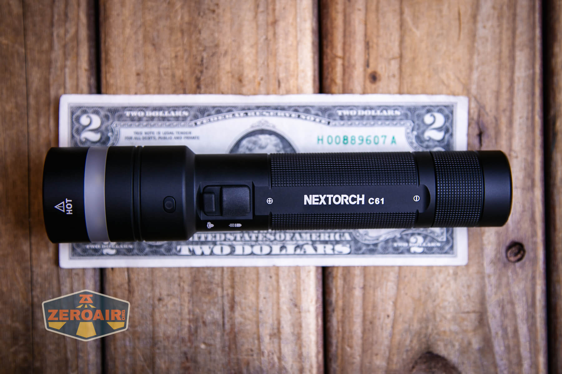 Nextorch C61 Dual-Beam flashlight on a two dollar bill