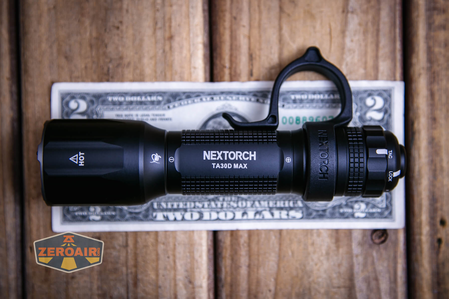 Nextorch TA30D MAX One-Step-Strobe flashlight on a two dollar bill