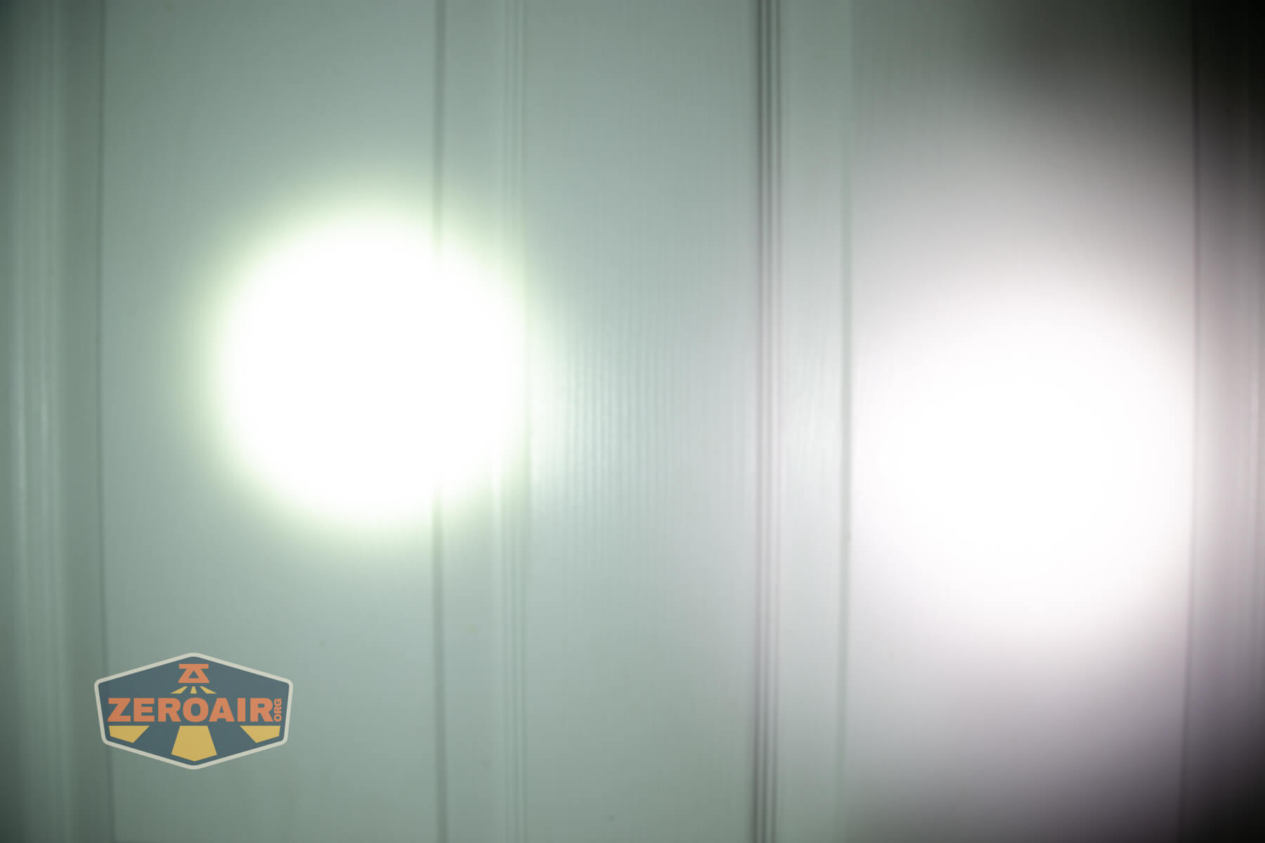 Nitecore EDC37 Flat EDC flashlight beamshots on door (at 1') compared to nichia 219b 4500K