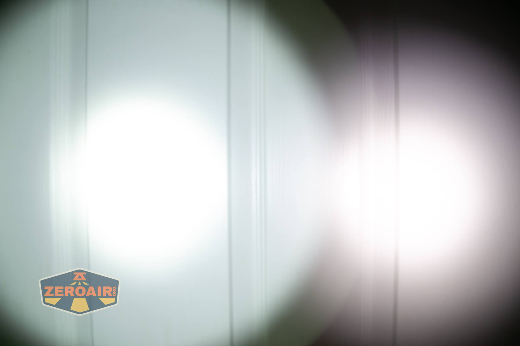 Sofirn SK30 tactical flashlight beamshots on door (at 1') compared to nichia 219b 4500K