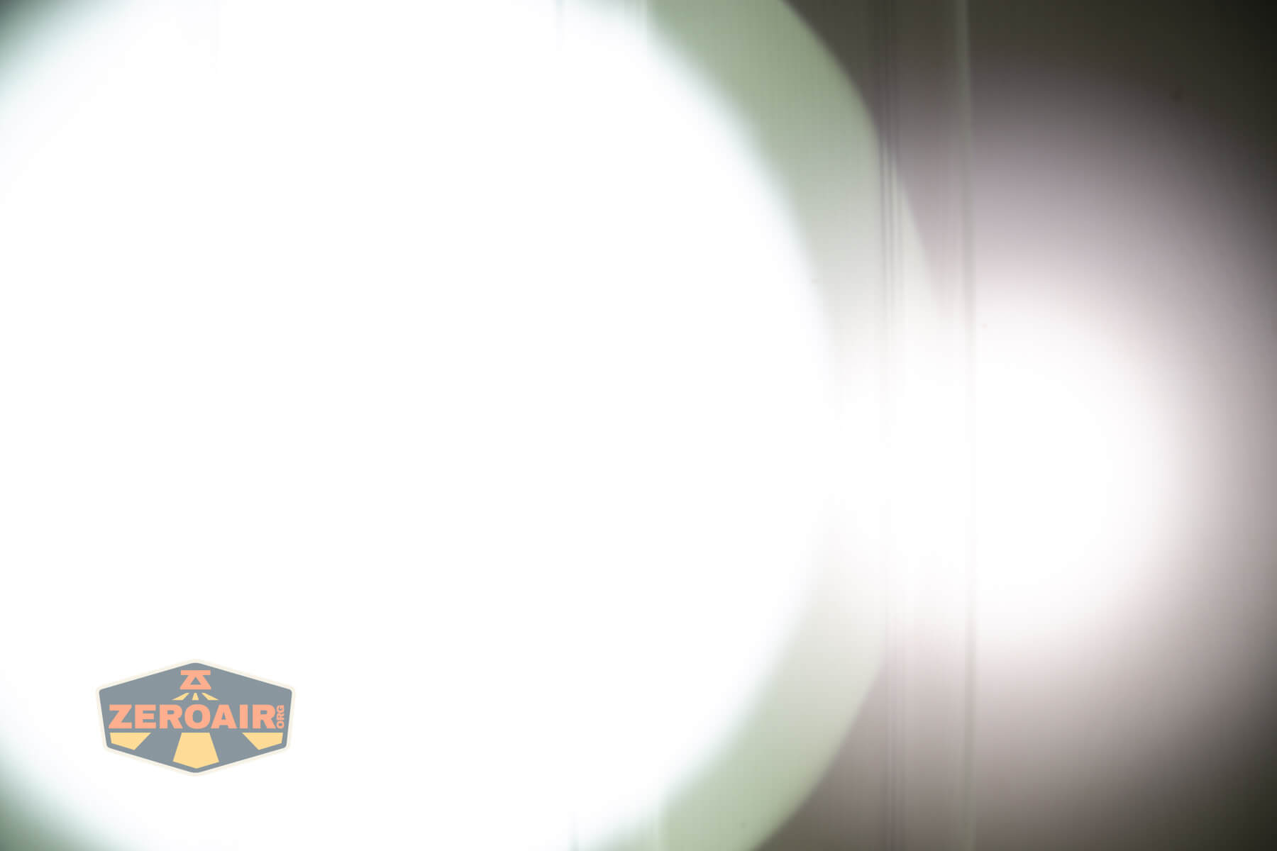 Sofirn SK30 tactical flashlight beamshots on door (at 1') compared to nichia 219b 4500K