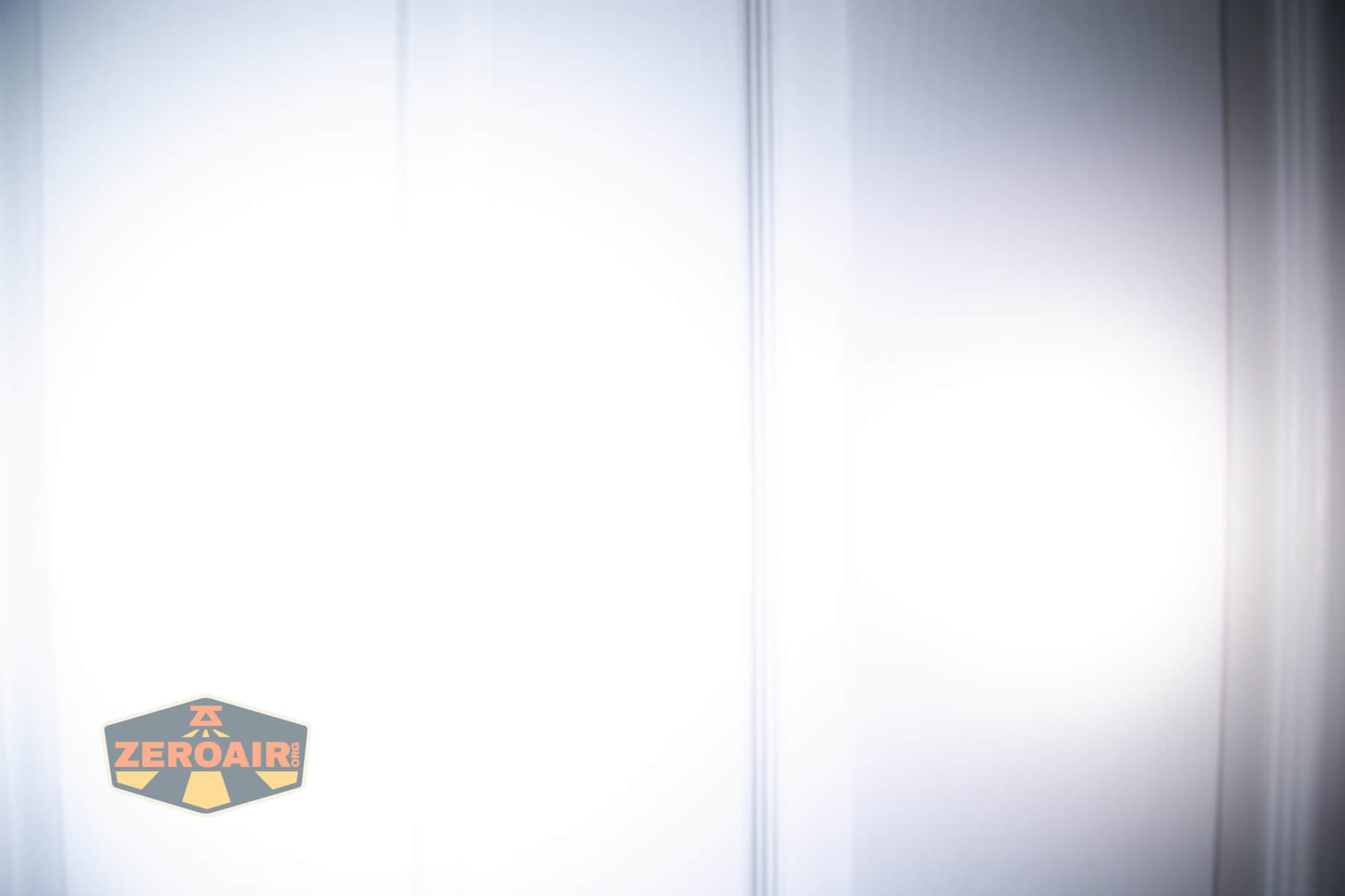 Cyansky Ark II EDC flat flashlight beamshots on door compared to nichia 219b