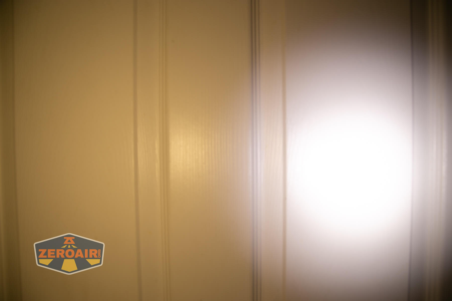 Cyansky Ark II EDC flat flashlight beamshots on door compared to nichia 219b