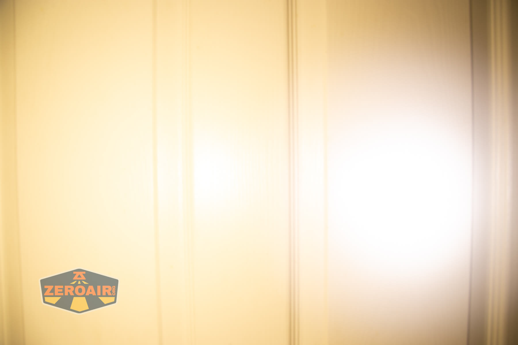 Cyansky Ark II EDC flat flashlight beamshots on door compared to nichia 219b