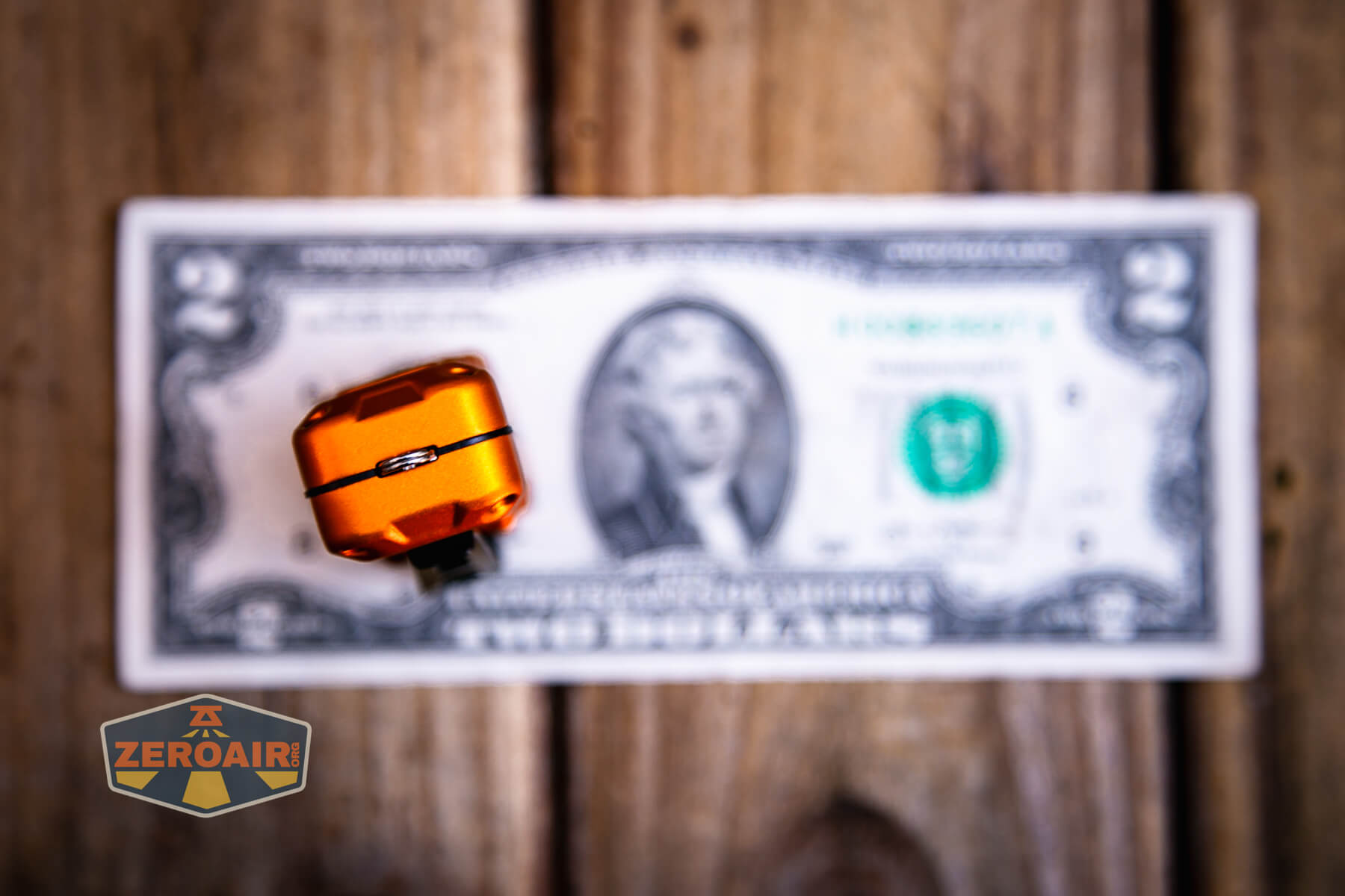 Nitecore TUP2 rechargeable keychain flashlight on two dollar bill