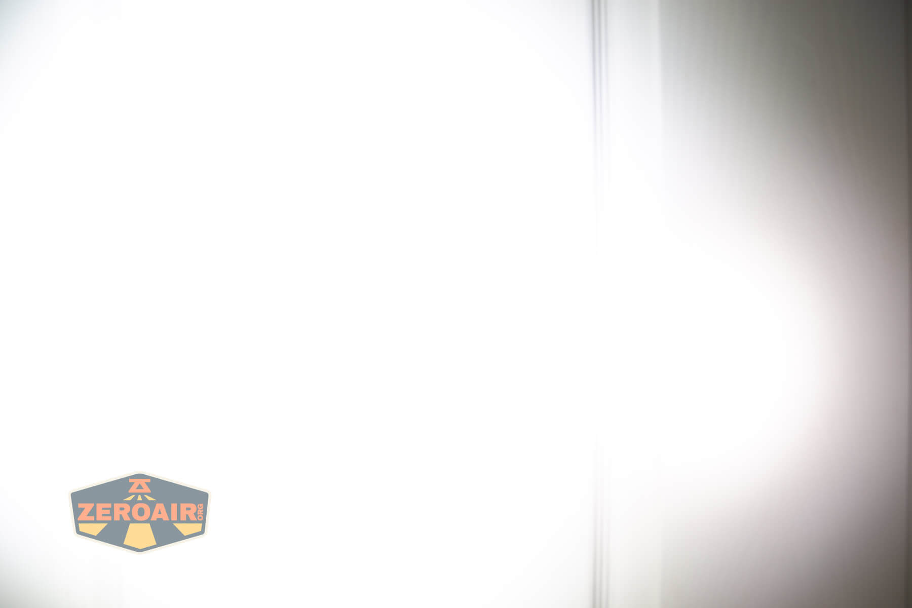 Nitecore TUP2 rechargeable keychain flashlight beamshots on door compared to nichia 219b