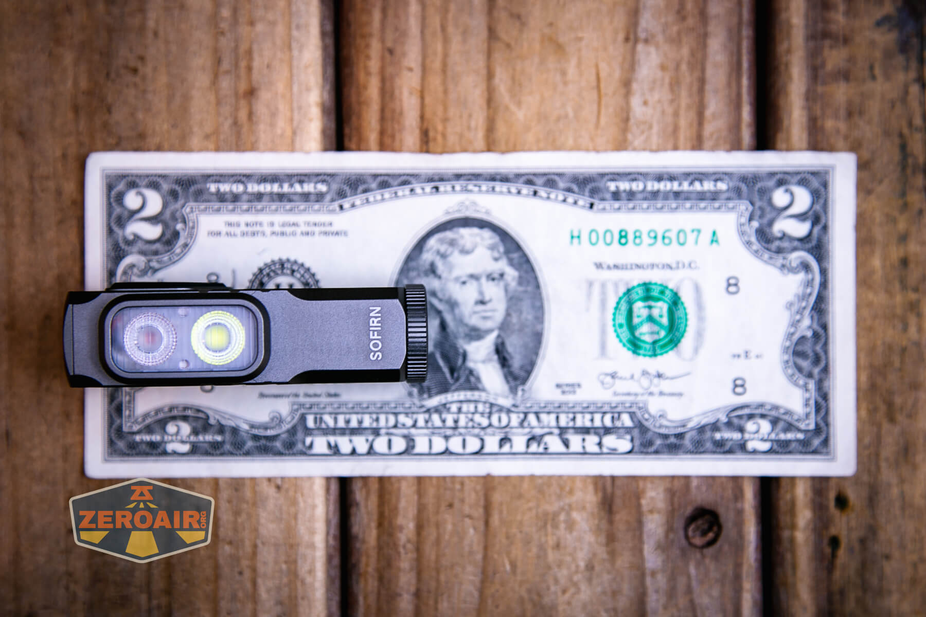 Sofirn ST10 Clip-on mini flashlight on two dollar bill