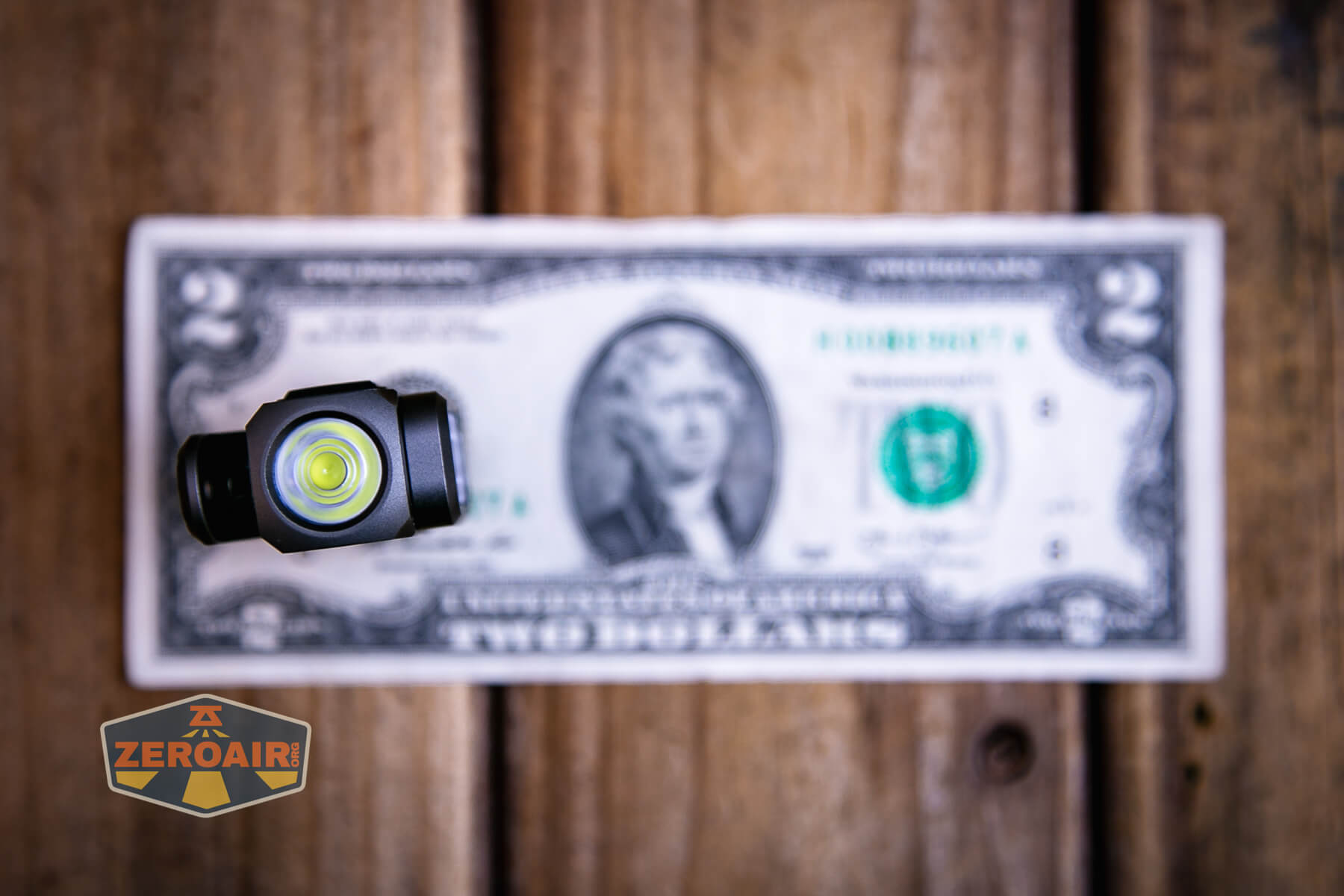 Sofirn ST10 Clip-on mini flashlight on two dollar bill
