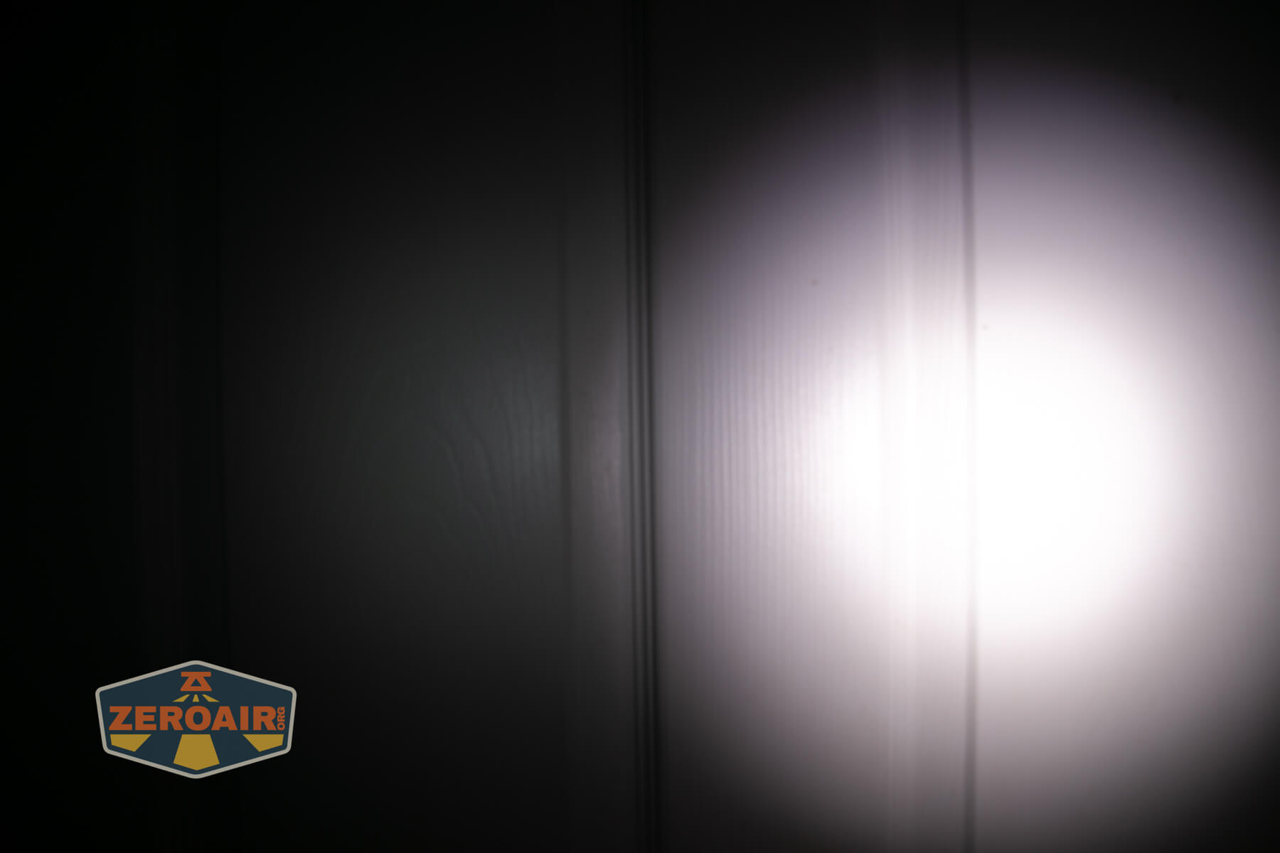 Sofirn ST10 Clip-on mini flashlight beamshots on door compared to nichia 219b