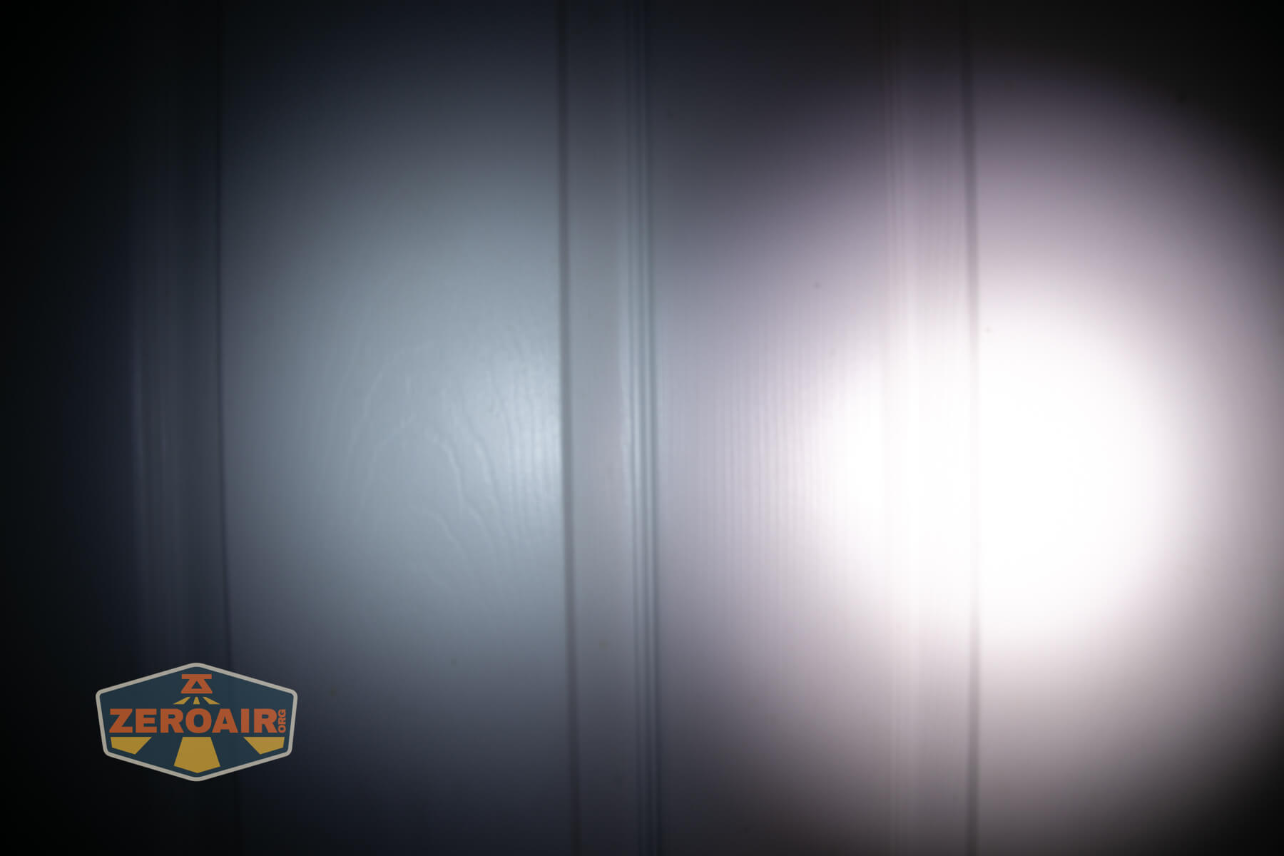 Sofirn ST10 Clip-on mini flashlight beamshots on door compared to nichia 219b