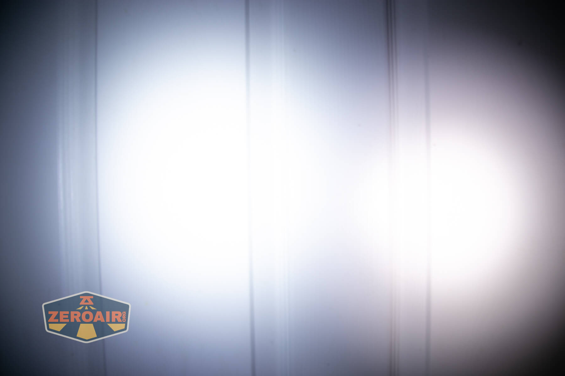 Sofirn ST10 Clip-on mini flashlight beamshots on door compared to nichia 219b