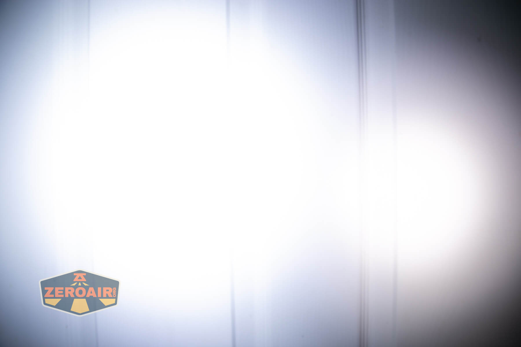 Sofirn ST10 Clip-on mini flashlight beamshots on door compared to nichia 219b