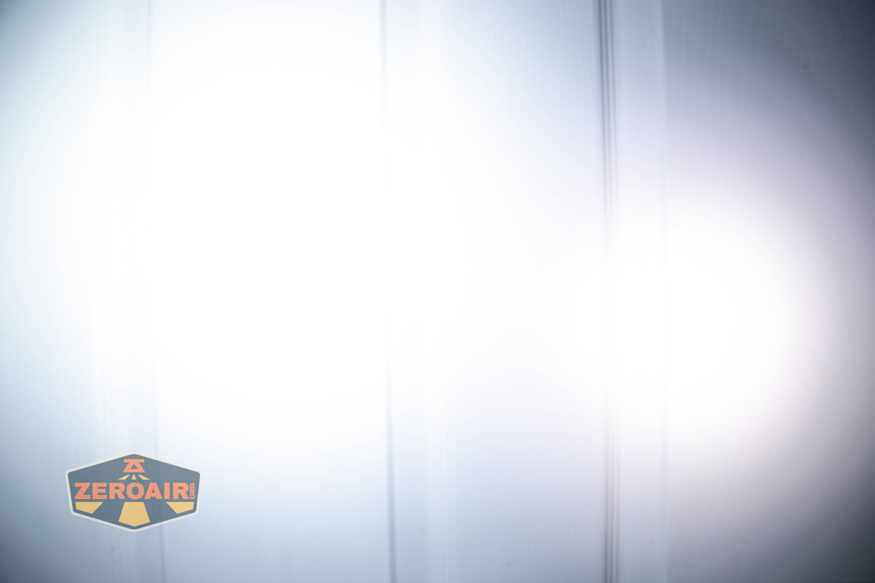 Sofirn ST10 Clip-on mini flashlight beamshots on door compared to nichia 219b