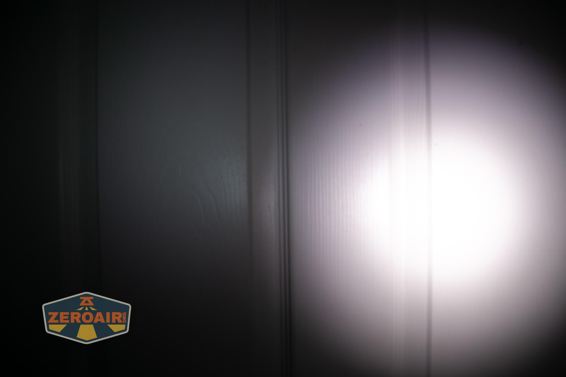 Sofirn ST10 Clip-on mini flashlight beamshots on door compared to nichia 219b