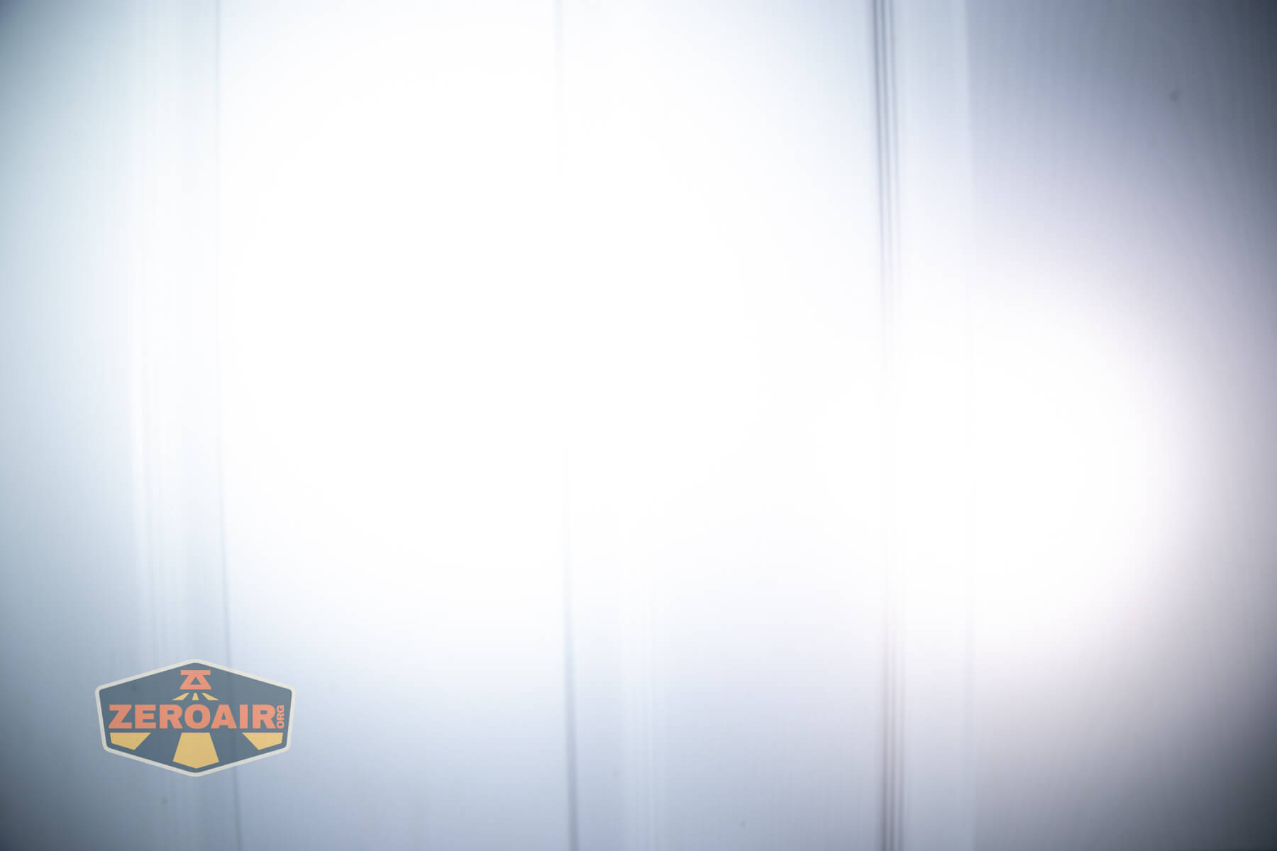 Sofirn ST10 Clip-on mini flashlight beamshots on door compared to nichia 219b