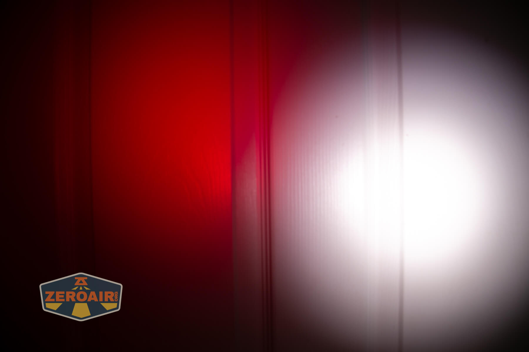 Sofirn ST10 Clip-on mini flashlight beamshots on door compared to nichia 219b