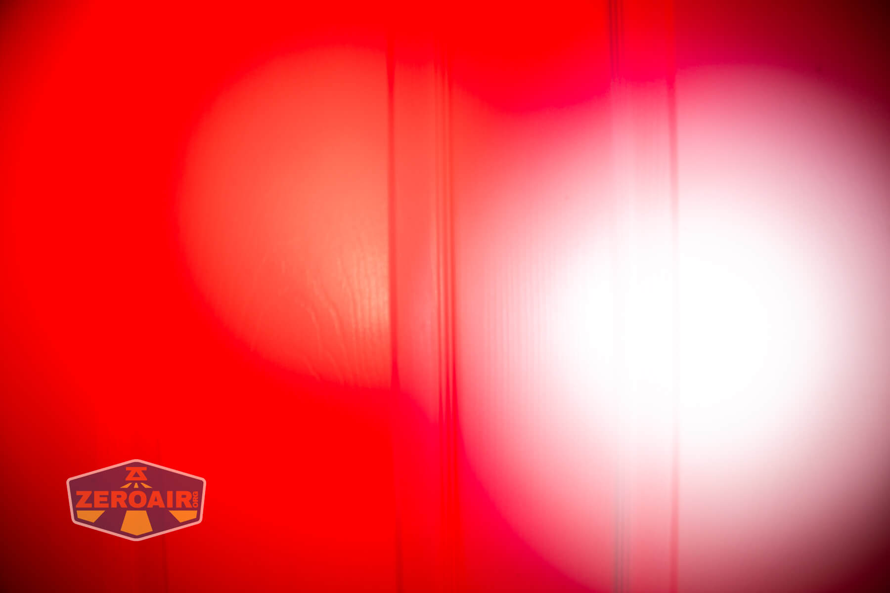 Sofirn ST10 Clip-on mini flashlight beamshots on door compared to nichia 219b