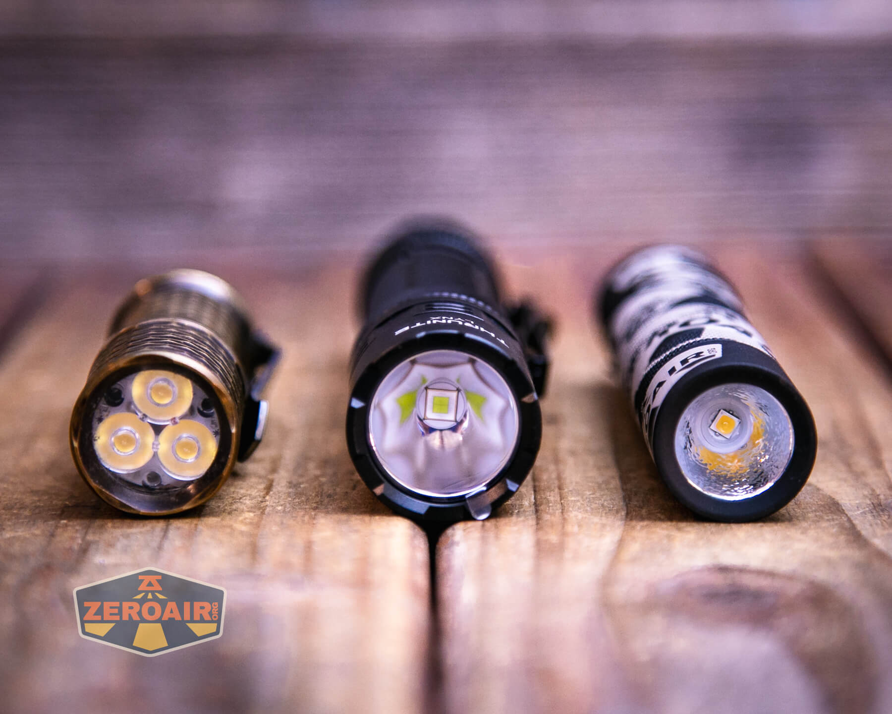 Thrunite Lynx flashlight with two standard sized flashlights