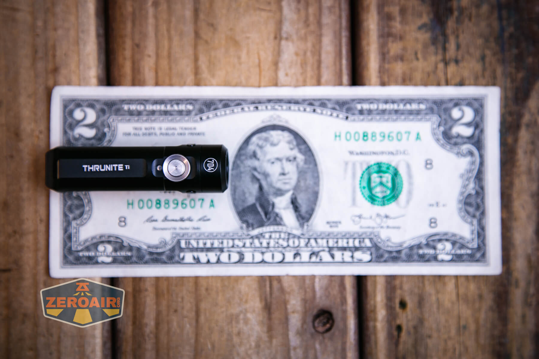 Thrunite Ti keychain flashlight on two dollar bill