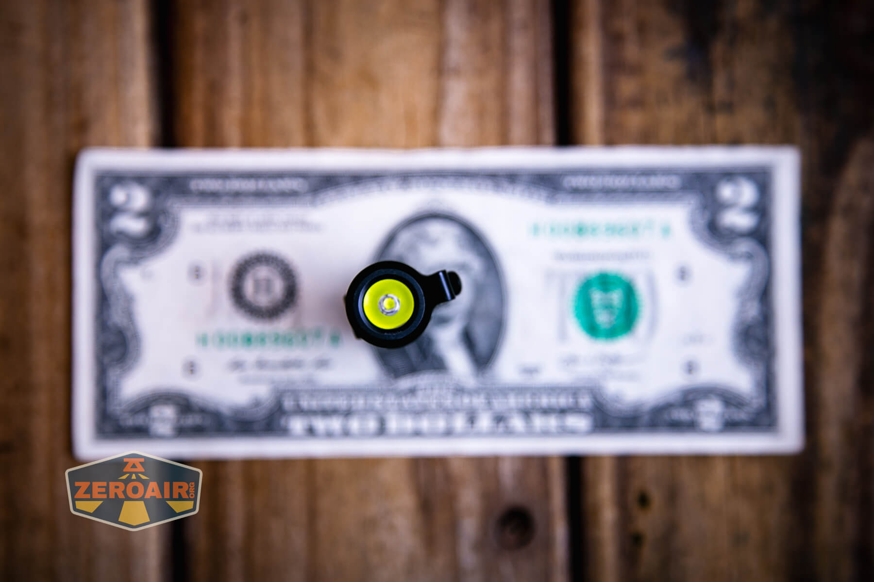 Thrunite Ti keychain flashlight on two dollar bill