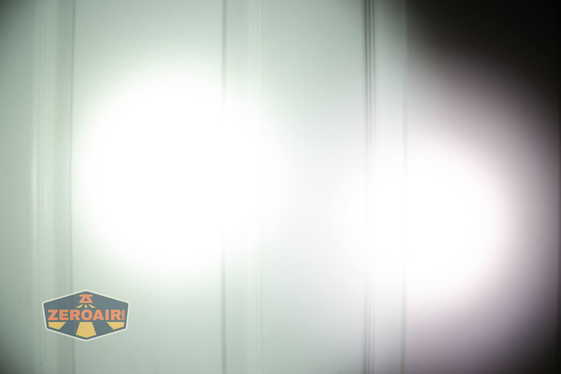 Wuben X1Pro Flashlight beamshots on door compared to Nichia 219b