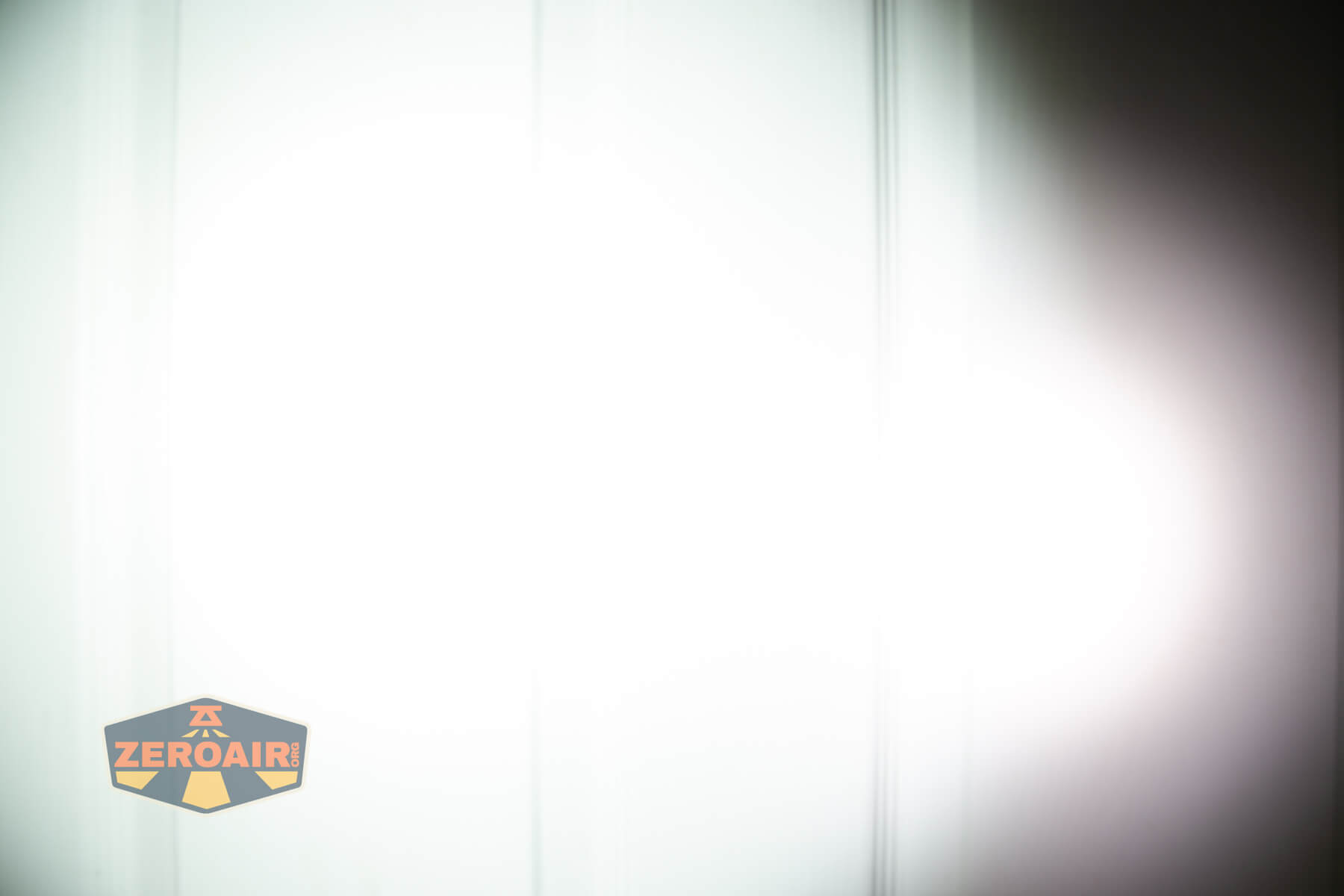 Wuben X1Pro Flashlight beamshots on door compared to Nichia 219b