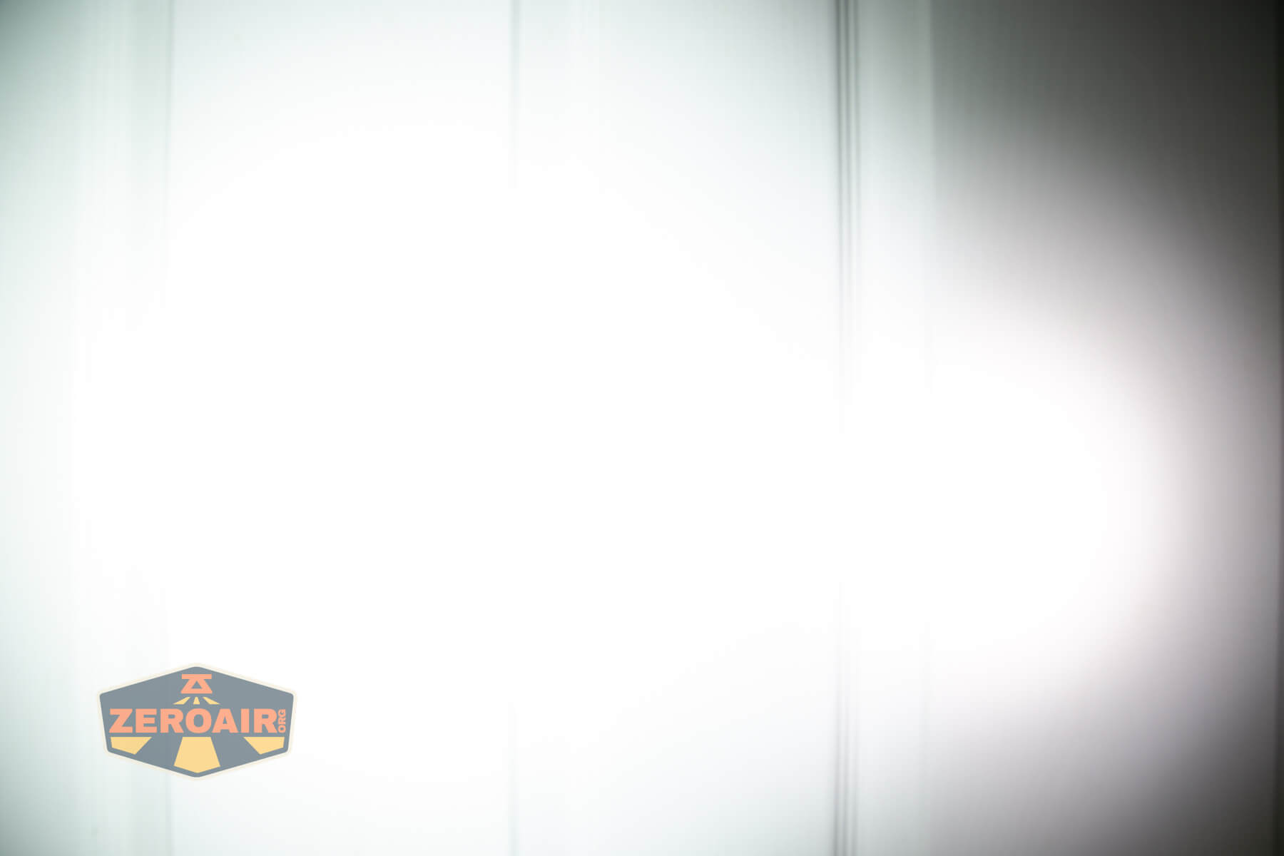 Wuben X1Pro Flashlight beamshots on door compared to Nichia 219b