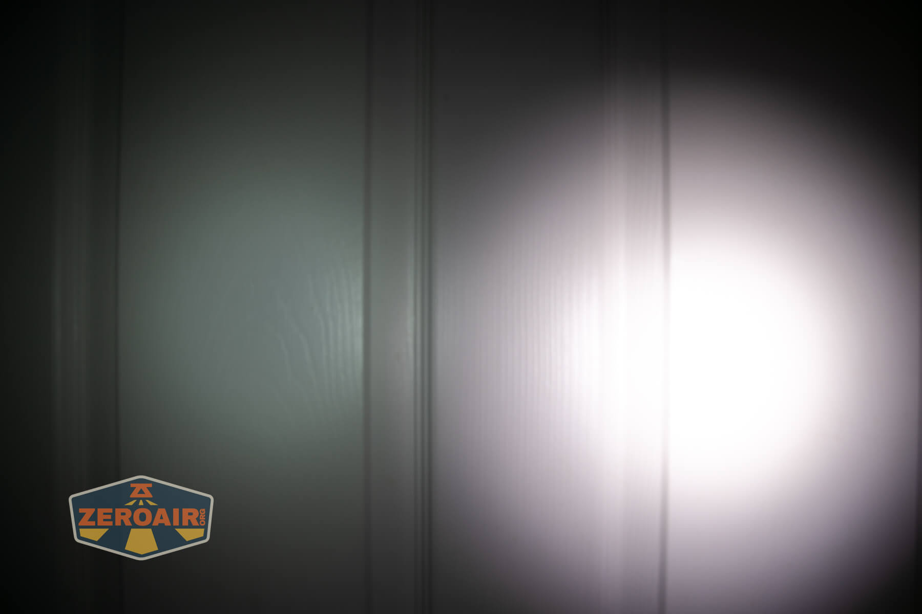 Wuben X1Pro Flashlight beamshots on door compared to Nichia 219b